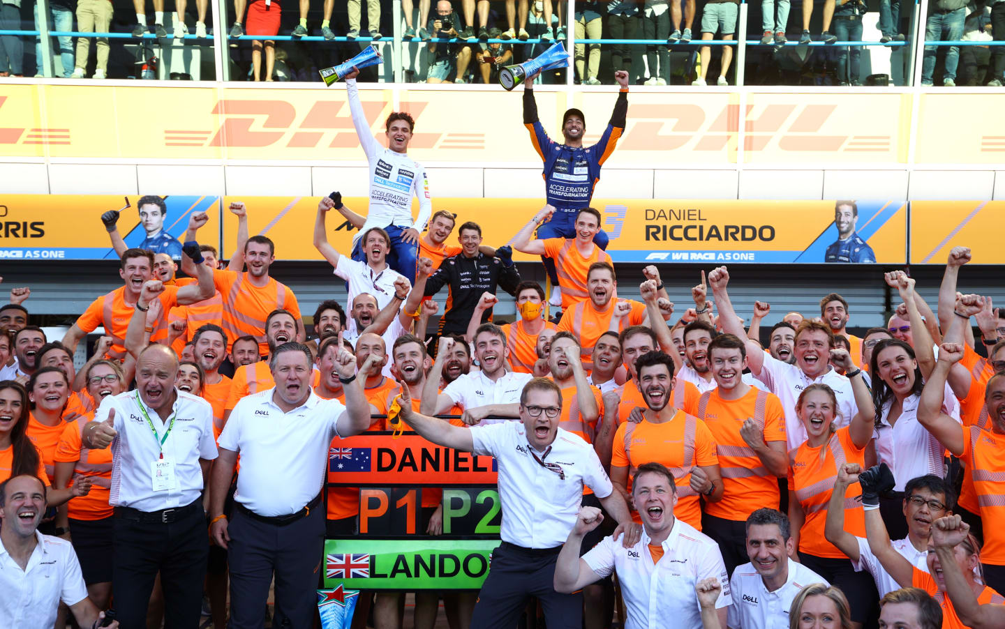 MONZA, ITALY - SEPTEMBER 12: Race winner Daniel Ricciardo of Australia and McLaren F1 and second placed Lando Norris of Great Britain and McLaren F1 celebrate with their team after the F1 Grand Prix of Italy at Autodromo di Monza on September 12, 2021 in Monza, Italy. (Photo by Bryn Lennon/Getty Images)