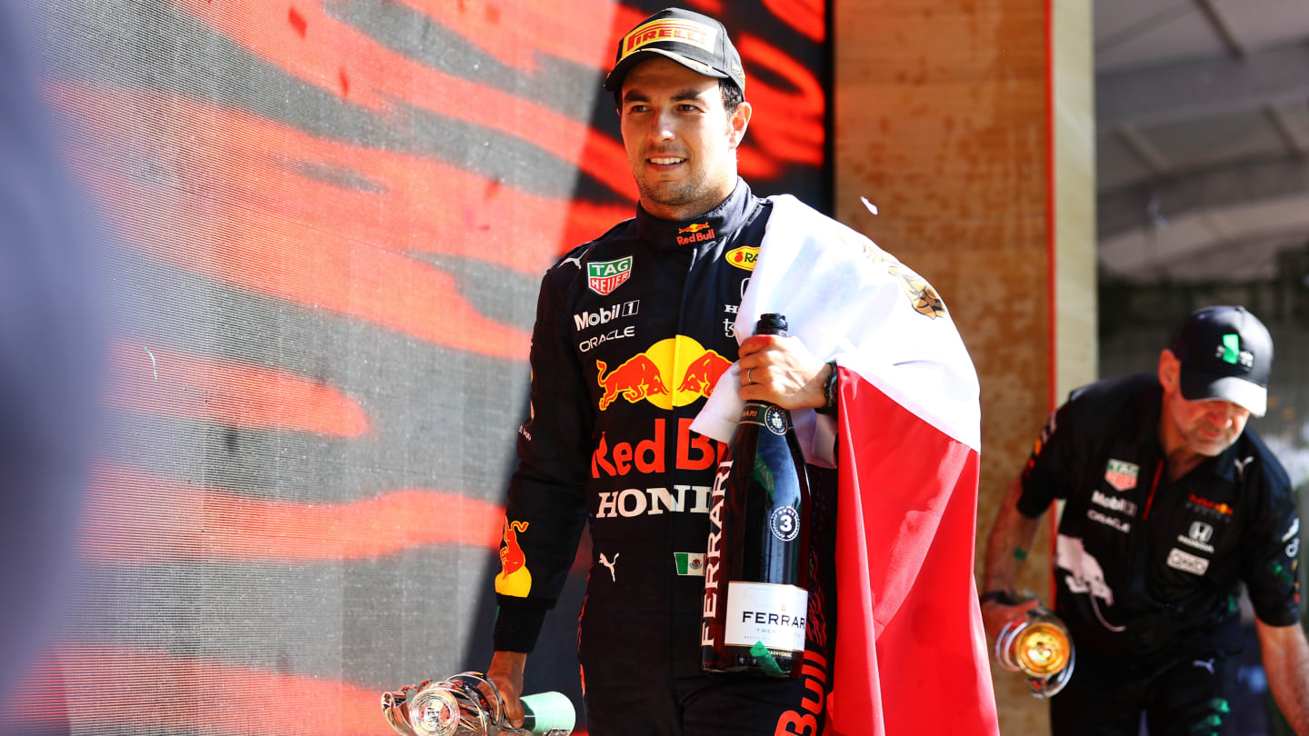 MEXICO CITY, MEXICO - NOVEMBER 07: Third placed Sergio Perez of Mexico and Red Bull Racing celebrates on the podium during the F1 Grand Prix of Mexico at Autodromo Hermanos Rodriguez on November 07, 2021 in Mexico City, Mexico. (Photo by Bryn Lennon - Formula 1/Formula 1 via Getty Images)