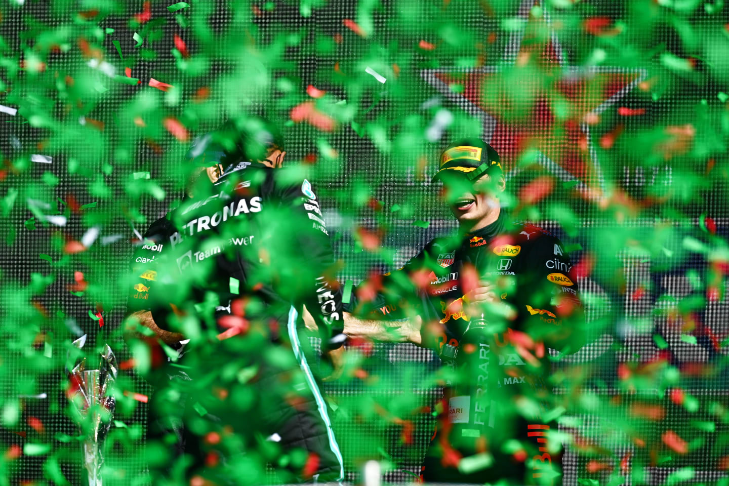 MEXICO CITY, MEXICO - NOVEMBER 07: Second placed Lewis Hamilton of Great Britain and Mercedes GP and third placed Sergio Perez of Mexico and Red Bull Racing celebrate on the podium during the F1 Grand Prix of Mexico at Autodromo Hermanos Rodriguez on November 07, 2021 in Mexico City, Mexico. (Photo by Clive Mason/Getty Images)