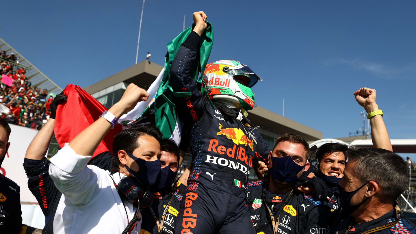 MEXICO CITY, MEXICO - NOVEMBER 07: Third placed Sergio Perez of Mexico and Red Bull Racing celebrates in parc ferme during the F1 Grand Prix of Mexico at Autodromo Hermanos Rodriguez on November 07, 2021 in Mexico City, Mexico. (Photo by Bryn Lennon - Formula 1/Formula 1 via Getty Images)