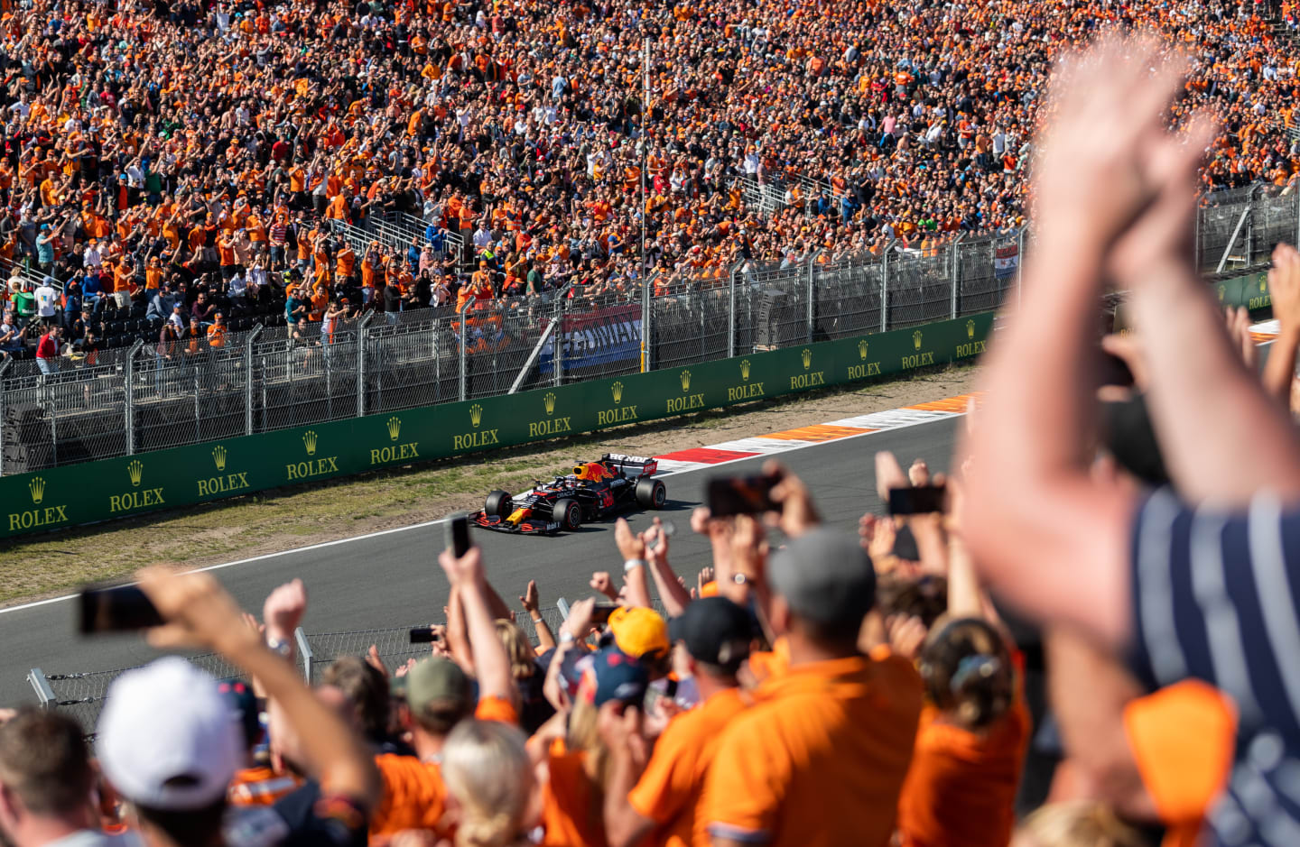 ZANDVOORT, NETHERLANDS - SEPTEMBER 04: Fans celebrate Max Verstappen of the Netherlands driving the (33) Red Bull Racing RB16B Honda during qualifying ahead of the F1 Grand Prix of The Netherlands at Circuit Zandvoort on September 04, 2021 in Zandvoort, Netherlands. (Photo by Boris Streubel/Getty Images)