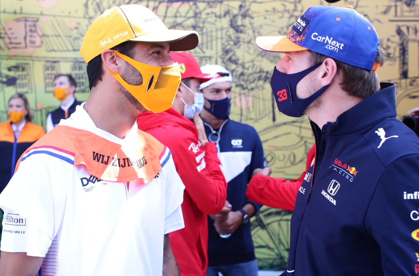 ZANDVOORT, NETHERLANDS - SEPTEMBER 05: Max Verstappen of Netherlands and Red Bull Racing and Daniel Ricciardo of Australia and McLaren F1 talk on the drivers parade ahead of the F1 Grand Prix of The Netherlands at Circuit Zandvoort on September 05, 2021 in Zandvoort, Netherlands. (Photo by Peter Fox/Getty Images)
