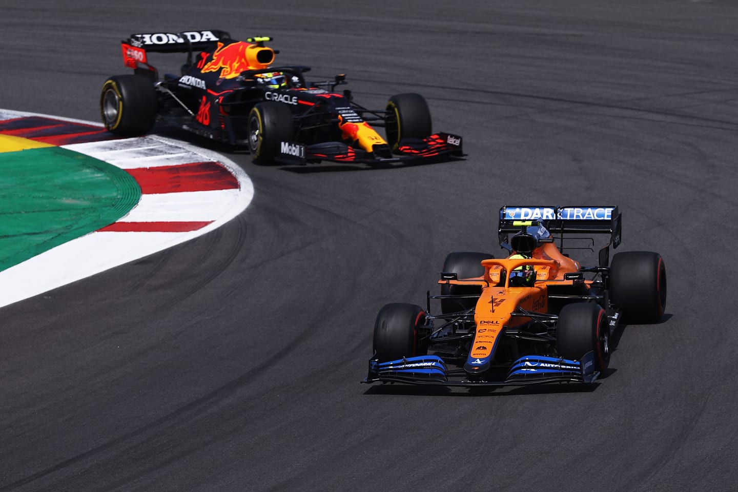 PORTIMAO, PORTUGAL - MAY 02: Lando Norris of Great Britain driving the (4) McLaren F1 Team MCL35M Mercedes leads Sergio Perez of Mexico driving the (11) Red Bull Racing RB16B Honda on track during the F1 Grand Prix of Portugal at Autodromo Internacional Do Algarve on May 02, 2021 in Portimao, Portugal. (Photo by Lars Baron/Getty Images)