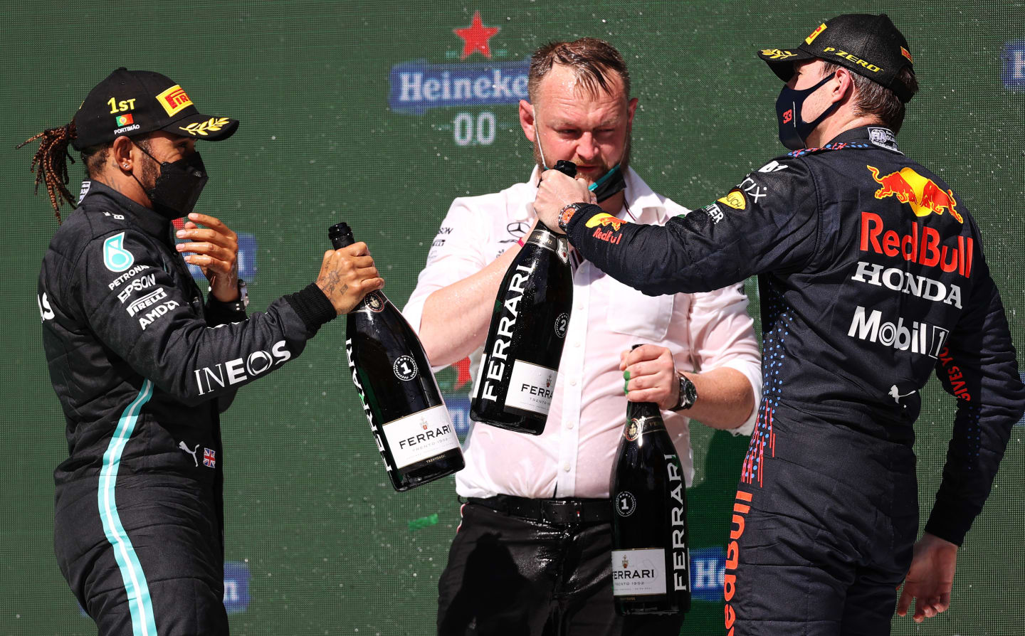PORTIMAO, PORTUGAL - MAY 02: Race winner Lewis Hamilton of Great Britain and Mercedes GP, Mercedes GP engineer Kane Hemmant and Second placed Max Verstappen of Netherlands and Red Bull Racing  celebrate with Sparkling wine on the podium during the F1 Grand Prix of Portugal at Autodromo Internacional Do Algarve on May 02, 2021 in Portimao, Portugal. (Photo by Lars Baron/Getty Images)