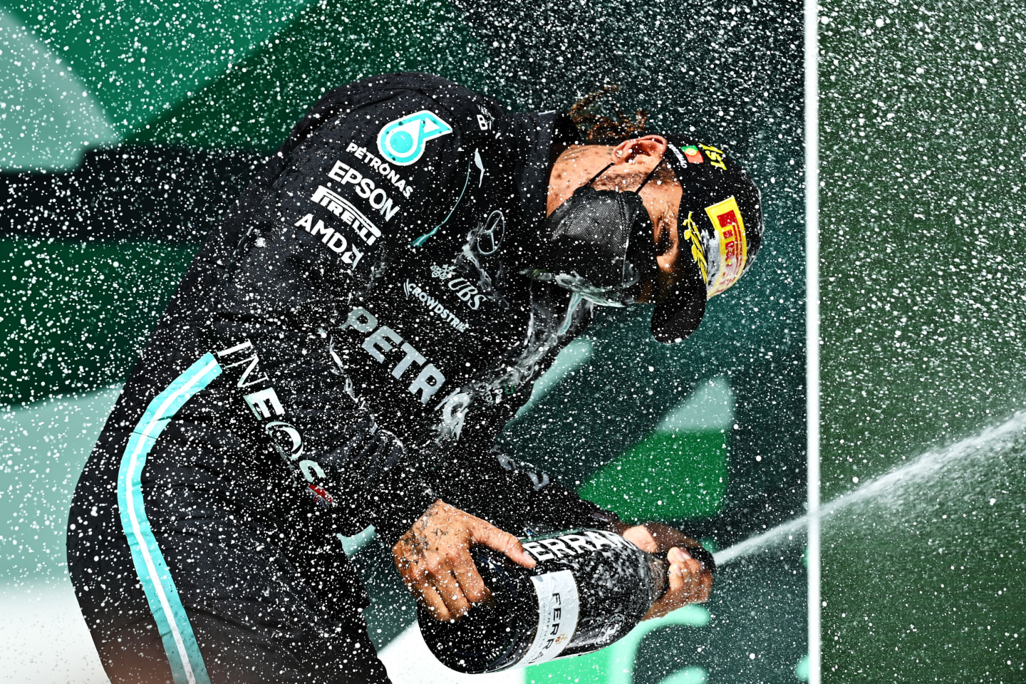 PORTIMAO, PORTUGAL - MAY 02: Race winner Lewis Hamilton of Great Britain and Mercedes GP celebrates with sparkling wine on the podium during the F1 Grand Prix of Portugal at Autodromo Internacional Do Algarve on May 02, 2021 in Portimao, Portugal. (Photo by Clive Mason - Formula 1/Formula 1 via Getty Images)