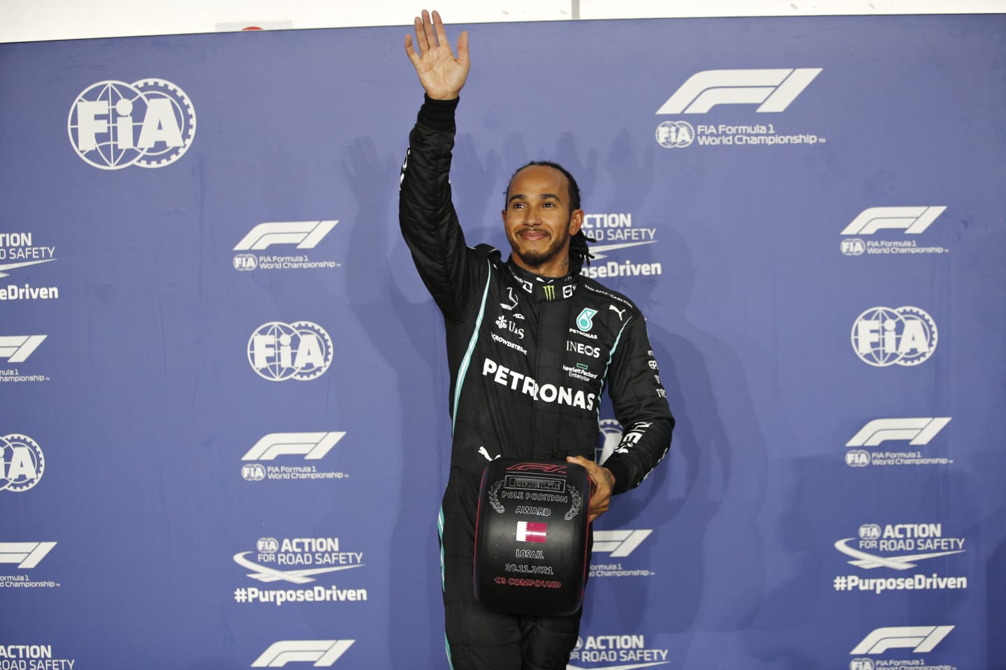 DOHA, QATAR - NOVEMBER 20: Pole position qualifier Lewis Hamilton of Great Britain and Mercedes GP waves to the crowd in parc ferme during qualifying ahead of the F1 Grand Prix of Qatar at Losail International Circuit on November 20, 2021 in Doha, Qatar. (Photo by Hamad I Mohammed - Pool/Getty Images)