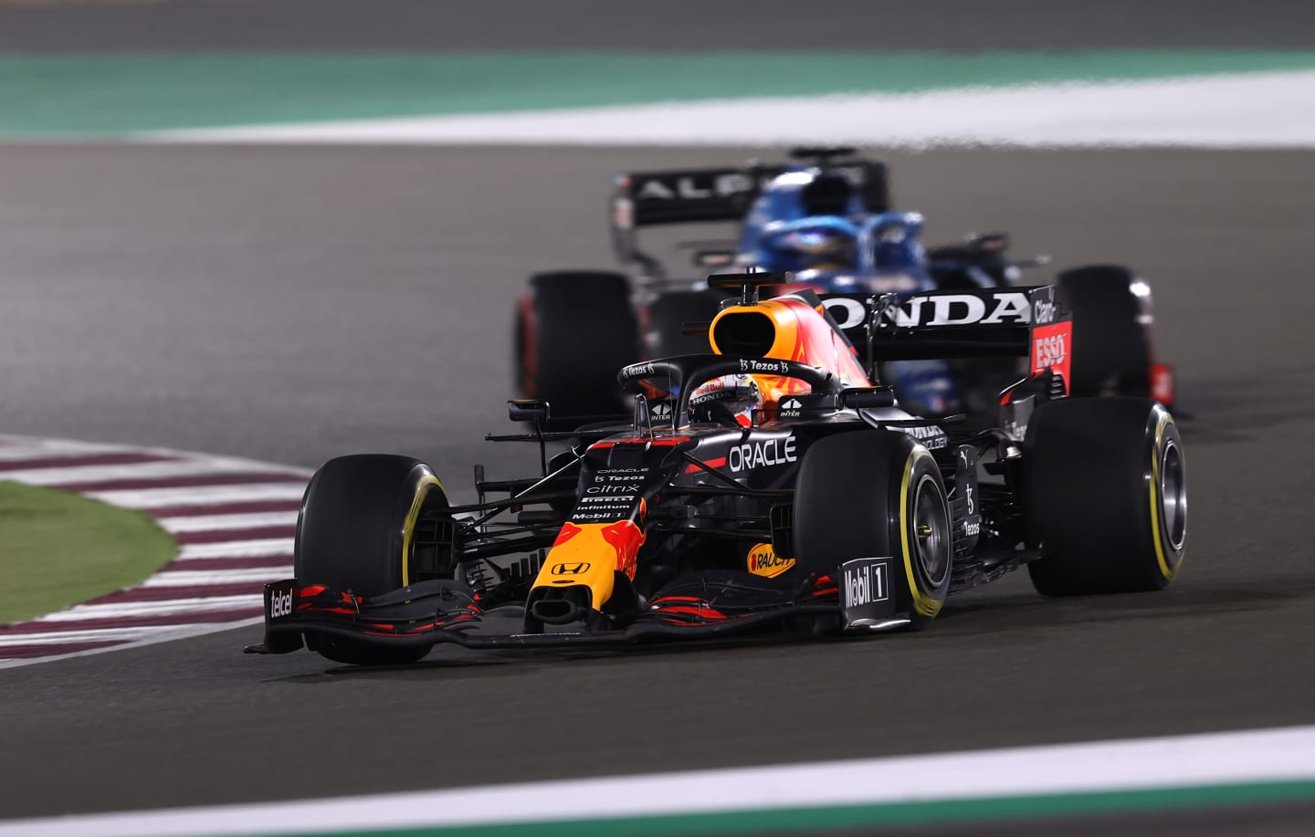 DOHA, QATAR - NOVEMBER 21: Max Verstappen of the Netherlands driving the (33) Red Bull Racing RB16B Honda leads Fernando Alonso of Spain driving the (14) Alpine A521 Renault during the F1 Grand Prix of Qatar at Losail International Circuit on November 21, 2021 in Doha, Qatar. (Photo by Lars Baron/Getty Images)