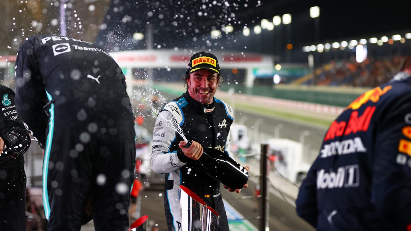 DOHA, QATAR - NOVEMBER 21: Race winner Lewis Hamilton of Great Britain and Mercedes GP and third placed Fernando Alonso of Spain and Alpine F1 Team celebrate on the podium during the F1 Grand Prix of Qatar at Losail International Circuit on November 21, 2021 in Doha, Qatar. (Photo by Dan Istitene - Formula 1/Formula 1 via Getty Images)