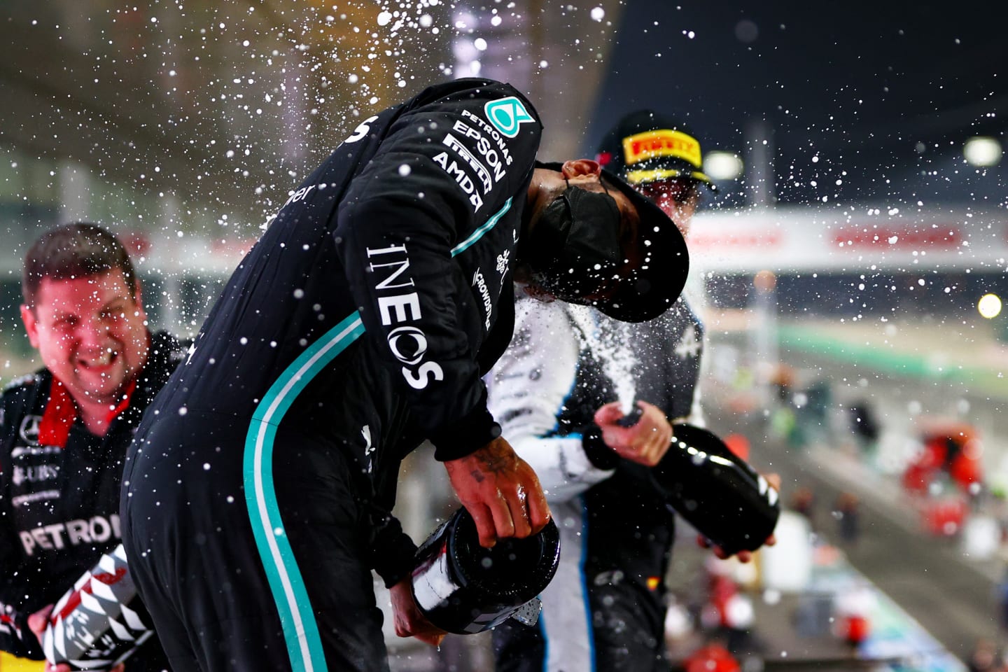 DOHA, QATAR - NOVEMBER 21: Race winner Lewis Hamilton of Great Britain and Mercedes GP, Second placed Max Verstappen of Netherlands and Red Bull Racing and Third placed Fernando Alonso of Spain and Alpine F1 Team celebrate on the podium during the F1 Grand Prix of Qatar at Losail International Circuit on November 21, 2021 in Doha, Qatar. (Photo by Dan Istitene - Formula 1/Formula 1 via Getty Images)