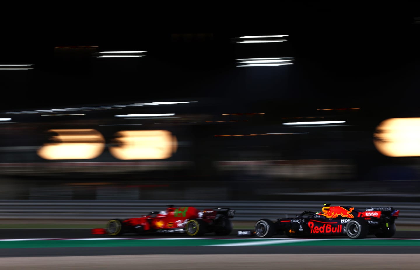 DOHA, QATAR - NOVEMBER 21: Charles Leclerc of Monaco driving the (16) Scuderia Ferrari SF21 leads