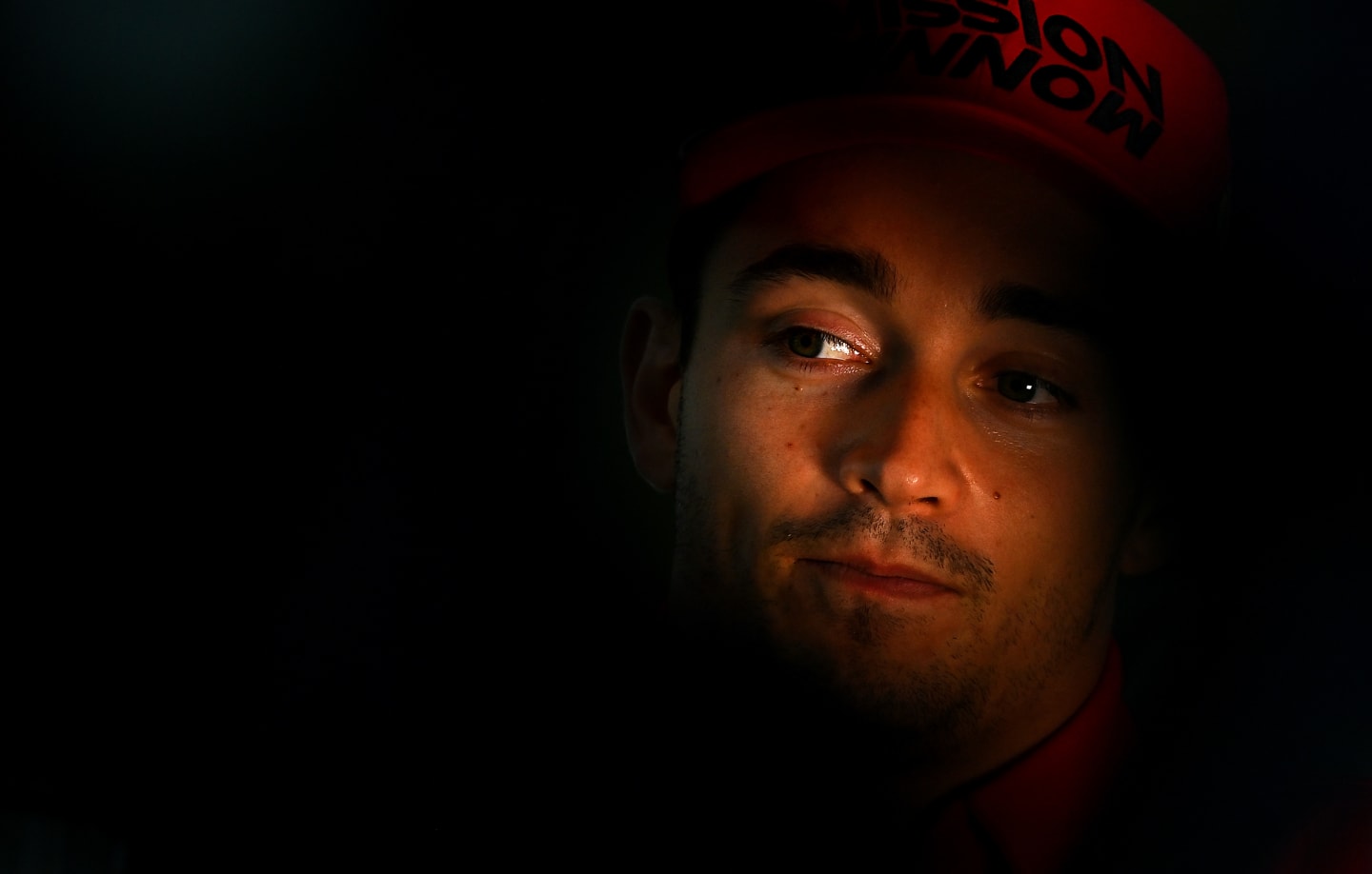 DOHA, QATAR - NOVEMBER 18: Charles Leclerc of Monaco and Ferrari looks on in the Paddock during