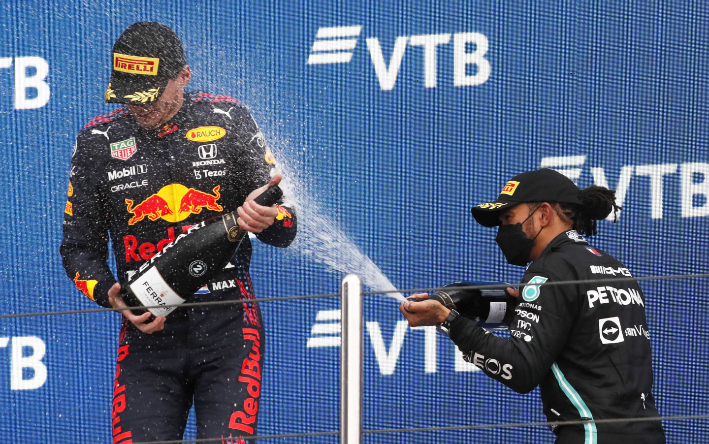 SOCHI, RUSSIA - SEPTEMBER 26: Race winner Lewis Hamilton of Great Britain and Mercedes GP celebrates on the podium with second placed Max Verstappen of Netherlands and Red Bull Racing during the F1 Grand Prix of Russia at Sochi Autodrom on September 26, 2021 in Sochi, Russia. (Photo by Yuri Kochetkov - Pool/Getty Images)