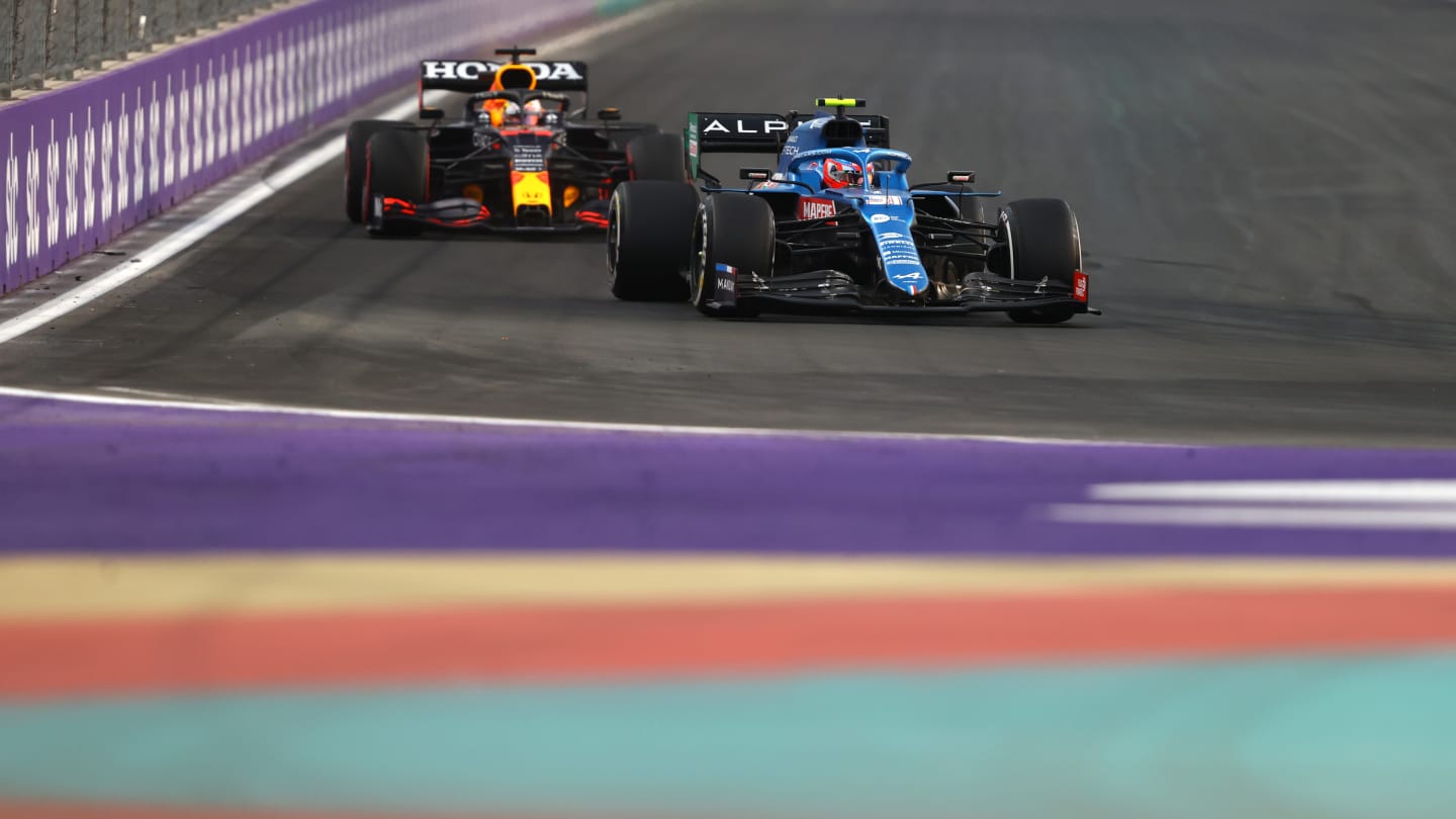 JEDDAH, SAUDI ARABIA - DECEMBER 03: Esteban Ocon of France driving the (31) Alpine A521 Renault leads Max Verstappen of the Netherlands driving the (33) Red Bull Racing RB16B Honda during practice ahead of the F1 Grand Prix of Saudi Arabia at Jeddah Corniche Circuit on December 03, 2021 in Jeddah, Saudi Arabia. (Photo by Bryn Lennon - Formula 1/Formula 1 via Getty Images)