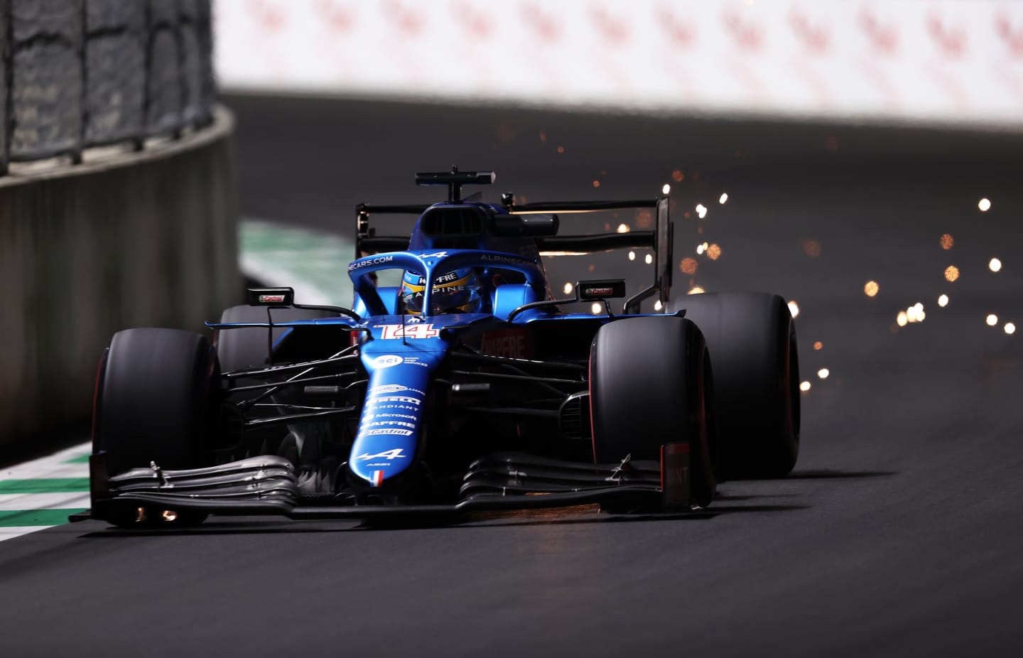 JEDDAH, SAUDI ARABIA - DECEMBER 03: Sparks fly behind Fernando Alonso of Spain driving the (14) Alpine A521 Renault during practice ahead of the F1 Grand Prix of Saudi Arabia at Jeddah Corniche Circuit on December 03, 2021 in Jeddah, Saudi Arabia. (Photo by Lars Baron/Getty Images)