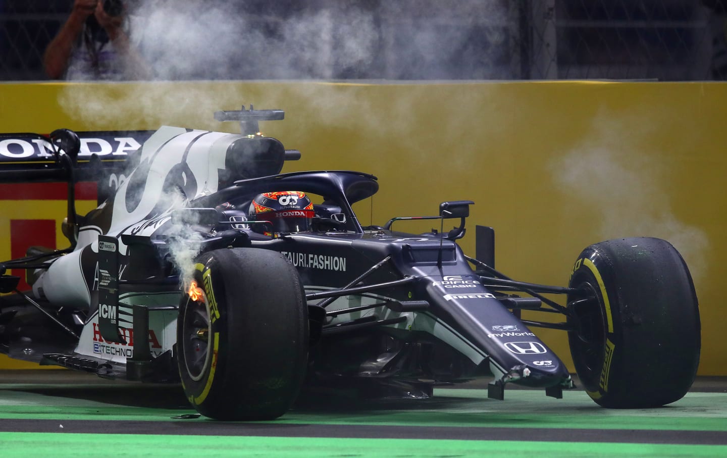 JEDDAH, SAUDI ARABIA - DECEMBER 05: Yuki Tsunoda of Japan driving the (22) Scuderia AlphaTauri AT02 Honda with a broken front wing and flaming brakes after a crash  during the F1 Grand Prix of Saudi Arabia at Jeddah Corniche Circuit on December 05, 2021 in Jeddah, Saudi Arabia. (Photo by Joe Portlock - Formula 1/Formula 1 via Getty Images)