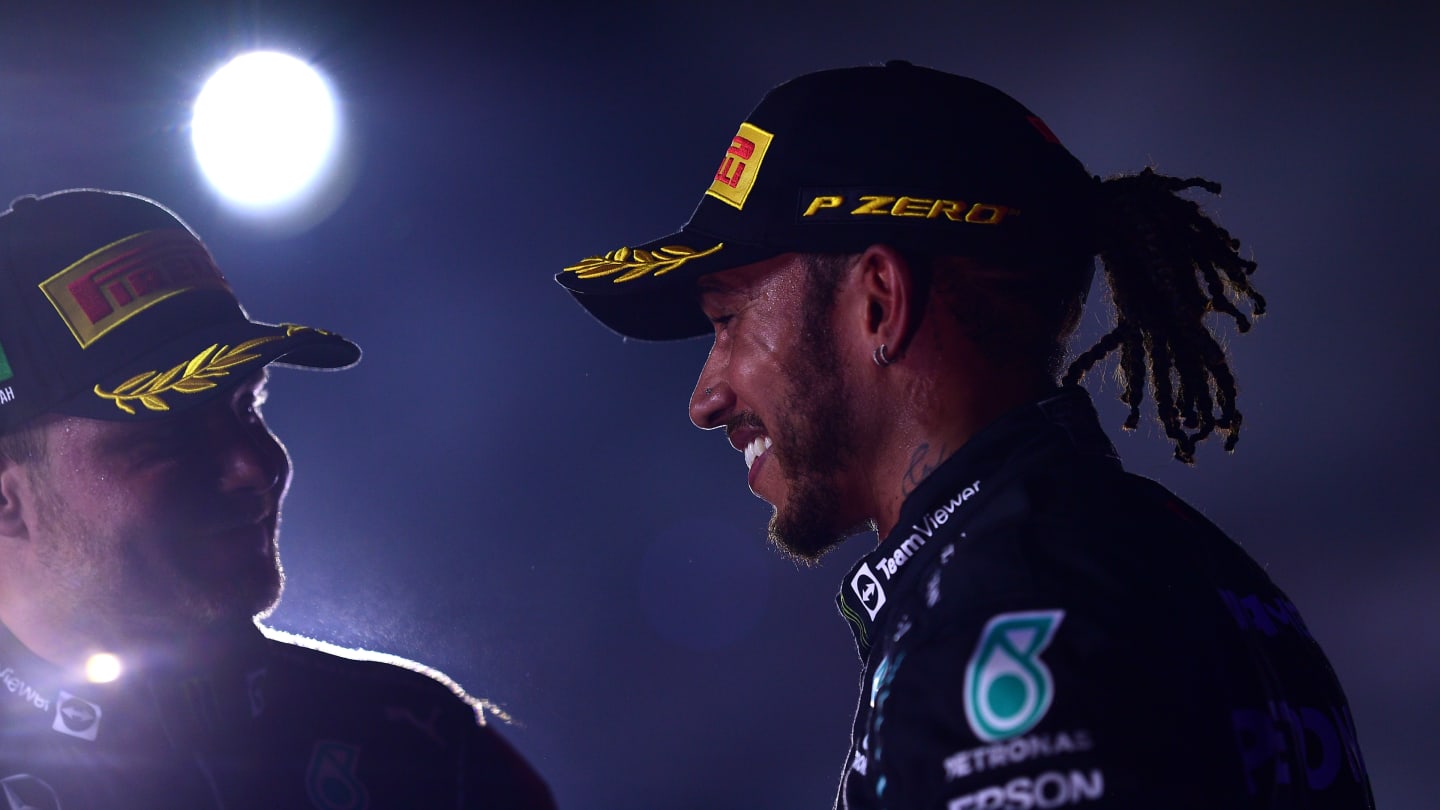 JEDDAH, SAUDI ARABIA - DECEMBER 05: Race winner Lewis Hamilton of Great Britain and Mercedes GP and third placed Valtteri Bottas of Finland and Mercedes GP celebrate on the podium during the F1 Grand Prix of Saudi Arabia at Jeddah Corniche Circuit on December 05, 2021 in Jeddah, Saudi Arabia. (Photo by Mario Renzi - Formula 1/Formula 1 via Getty Images)