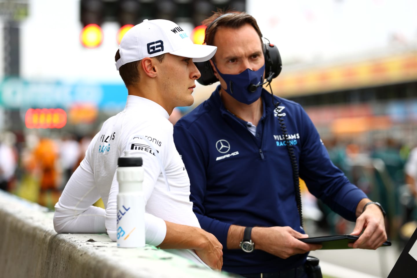 BARCELONA, SPAIN - MAY 09: George Russell of Great Britain and Williams prepares to drive on the grid with a team member prior to the F1 Grand Prix of Spain at Circuit de Barcelona-Catalunya on May 09, 2021 in Barcelona, Spain. (Photo by Bryn Lennon/Getty Images)