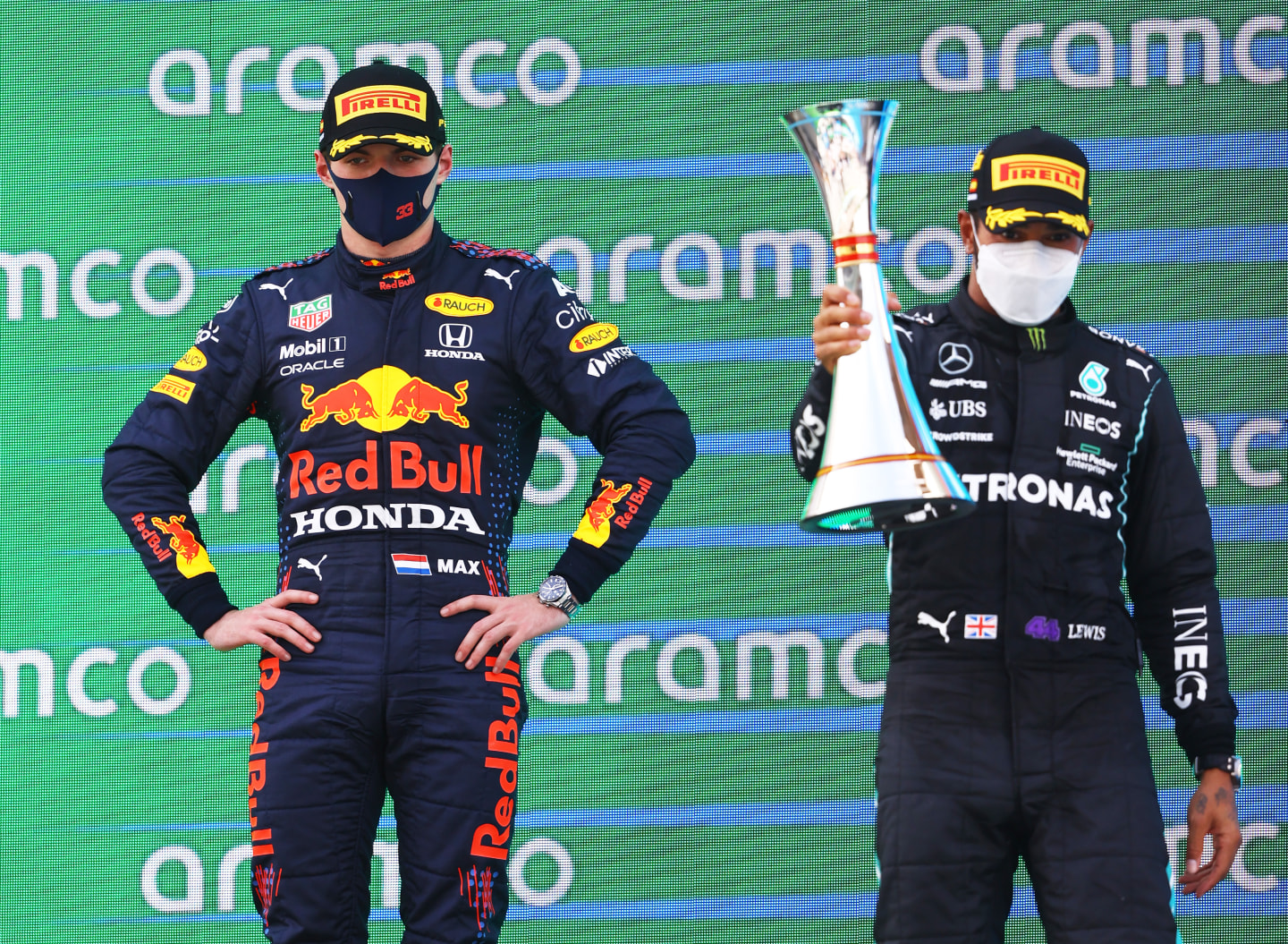 BARCELONA, SPAIN - MAY 09: Race winner Lewis Hamilton of Great Britain and Mercedes GP and second placed Max Verstappen of Netherlands and Red Bull Racing celebrate with sparkling wine on the podium during the F1 Grand Prix of Spain at Circuit de Barcelona-Catalunya on May 09, 2021 in Barcelona, Spain. (Photo by Bryn Lennon/Getty Images)
