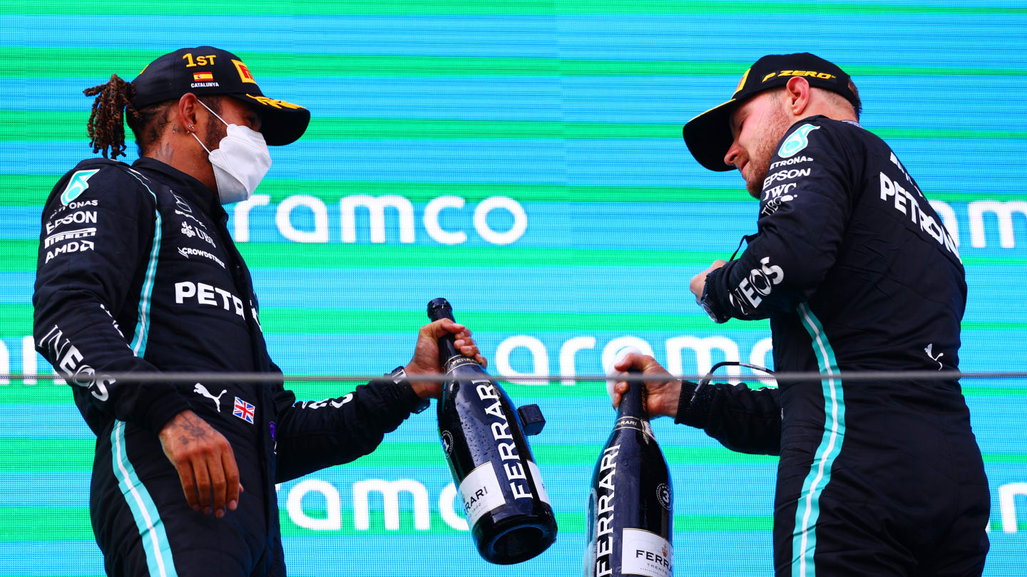BARCELONA, SPAIN - MAY 09:  Lewis Hamilton of Great Britain  Mercedes AMG Petronas celebrates on the podium with Valtteri Bottas of Finland and Mercedes AMG Petronas after winning the F1 Grand Prix of Spain at Circuit de Barcelona-Catalunya on May 09, 2021 in Barcelona, Spain. (Photo by Dan Istitene - Formula 1/Formula 1 via Getty Images)
