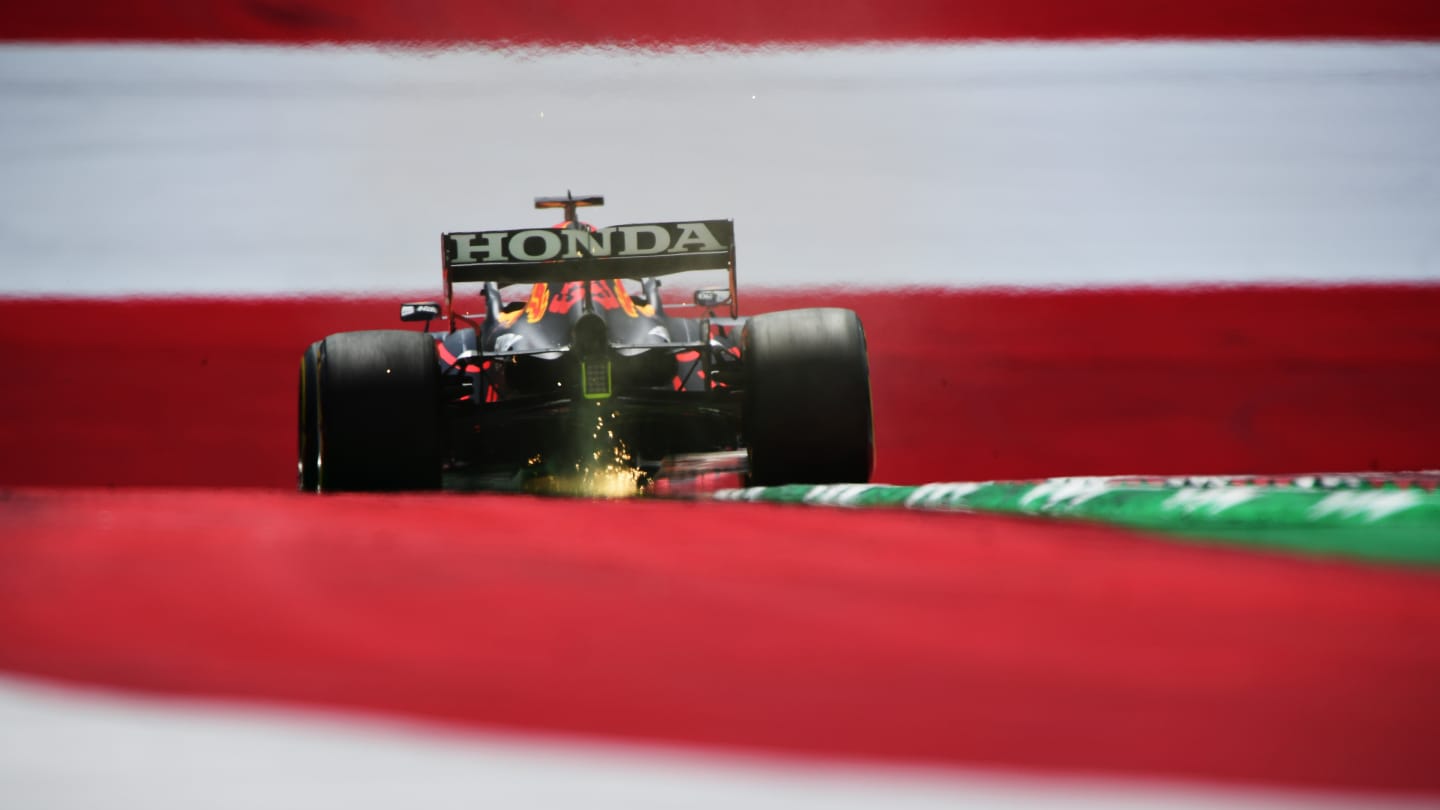 SPIELBERG, AUSTRIA - JUNE 25: Sparks fly behind Max Verstappen of the Netherlands driving the (33)