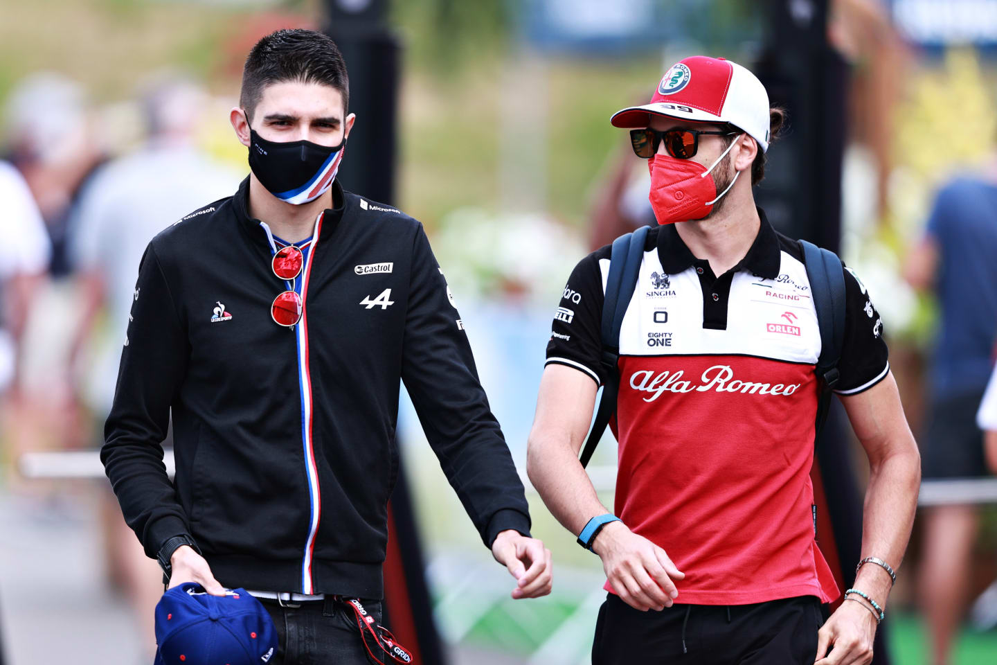 SPIELBERG, AUSTRIA - JUNE 25: Esteban Ocon of France and Alpine F1 Team and Antonio Giovinazzi of Italy and Alfa Romeo Racing talk in the Paddock before practice ahead of the F1 Grand Prix of Styria at Red Bull Ring on June 25, 2021 in Spielberg, Austria. (Photo by Mark Thompson/Getty Images)