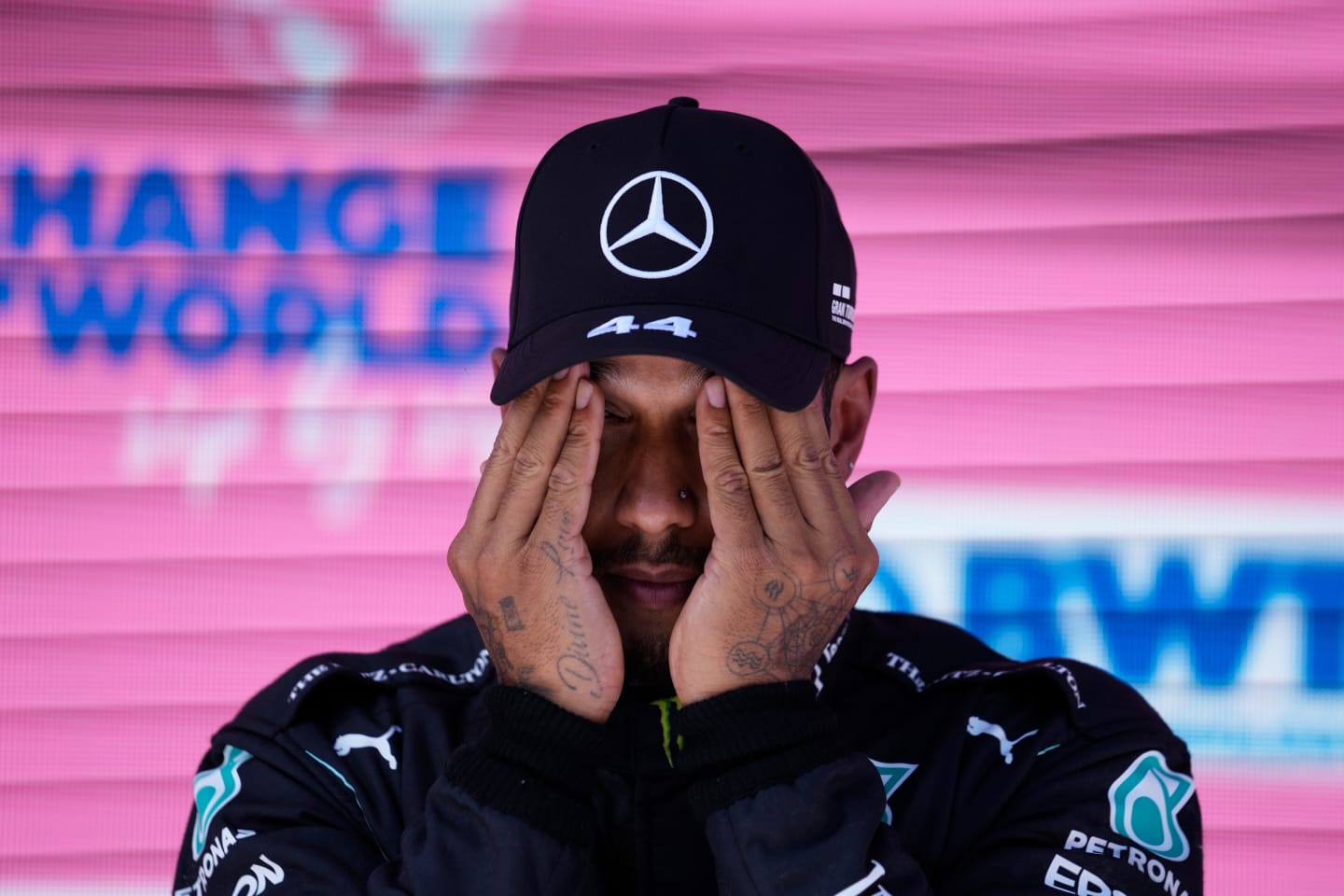 SPIELBERG, AUSTRIA - JUNE 26: Third place qualifier Lewis Hamilton of Great Britain and Mercedes GP wipes his face in parc ferme during qualifying ahead of the F1 Grand Prix of Styria at Red Bull Ring on June 26, 2021 in Spielberg, Austria. (Photo by Darko Vojinovic - Pool/Getty Images)