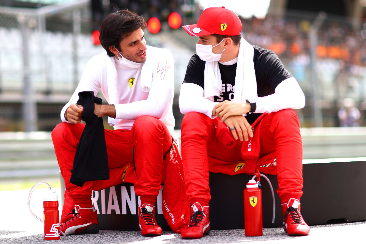SPIELBERG, AUSTRIA - JUNE 27: Carlos Sainz of Spain and Ferrari and Charles Leclerc of Monaco and Ferrari talk on the grid ahead of the F1 Grand Prix of Styria at Red Bull Ring on June 27, 2021 in Spielberg, Austria. (Photo by Dan Istitene - Formula 1/Formula 1 via Getty Images)