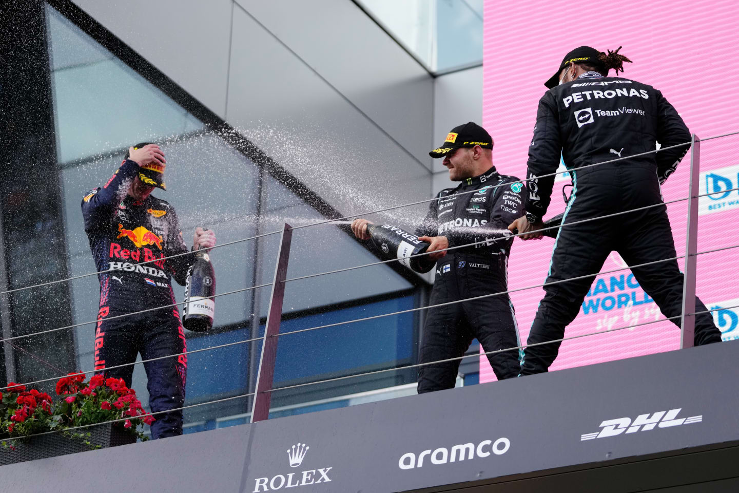 SPIELBERG, AUSTRIA - JUNE 27: Race winner Max Verstappen of Netherlands and Red Bull Racing, second placed Lewis Hamilton of Great Britain and Mercedes GP and third placed Valtteri Bottas of Finland and Mercedes GP celebrate on the podium during the F1 Grand Prix of Styria at Red Bull Ring on June 27, 2021 in Spielberg, Austria. (Photo by Darko Vojinovic - Pool/Getty Images)