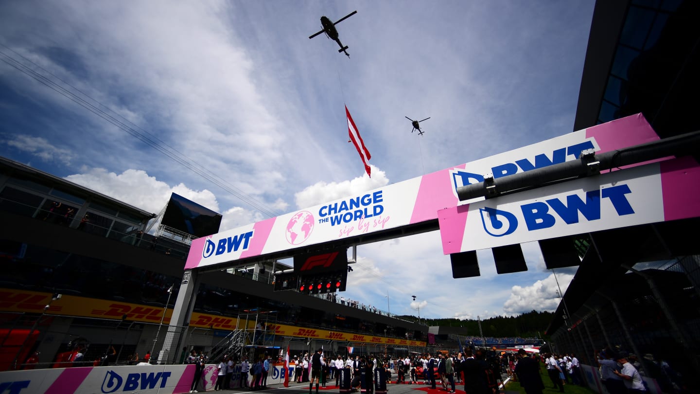 SPIELBERG, AUSTRIA - JUNE 27: A helicopter holding the Austrian flag flies above the circuit ahead
