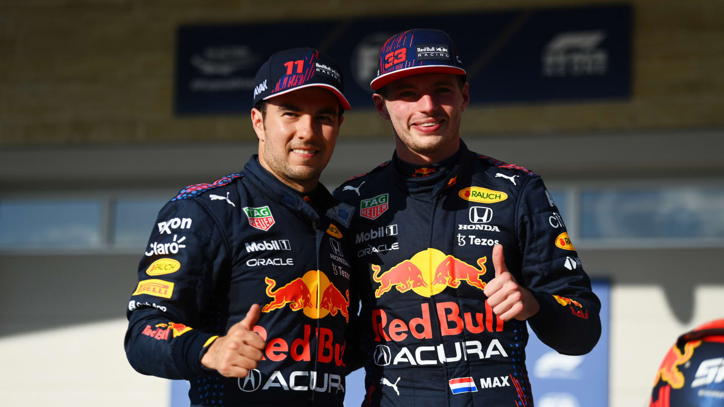 AUSTIN, TEXAS - OCTOBER 23: First place qualifier Max Verstappen of Netherlands and Red Bull Racing and third place qualifier Sergio Perez of Mexico and Red Bull Racing celebrate in parc ferme during qualifying ahead of the F1 Grand Prix of USA at Circuit of The Americas on October 23, 2021 in Austin, Texas. (Photo by Clive Mason - Formula 1/Formula 1 via Getty Images)