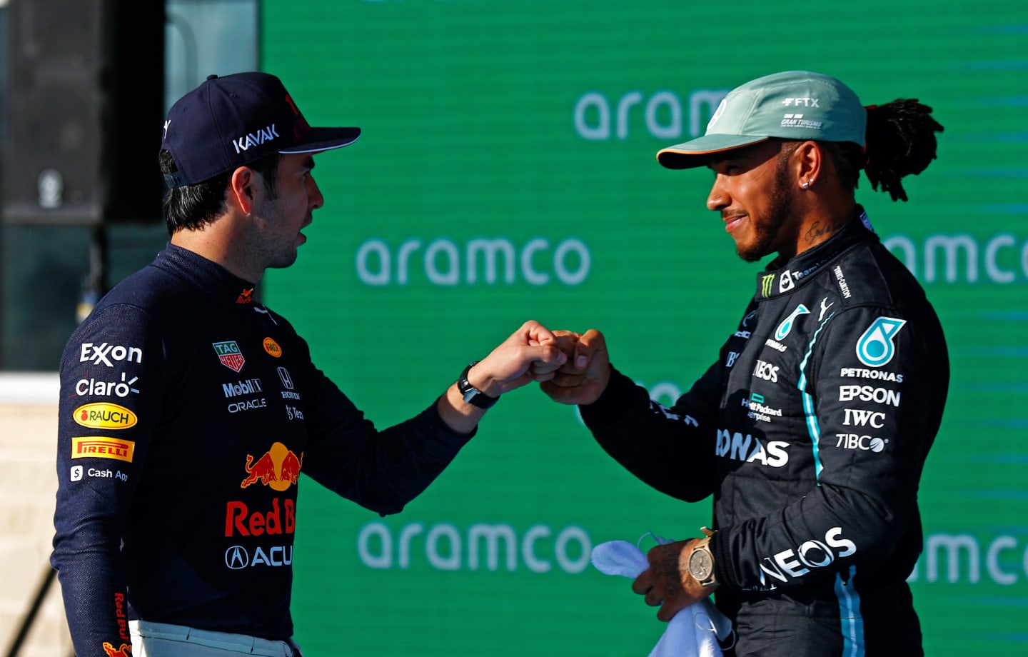 AUSTIN, TEXAS - OCTOBER 23: Second place qualifier Lewis Hamilton of Great Britain and Mercedes GP and third place qualifier Sergio Perez of Mexico and Red Bull Racing celebrate in parc ferme during qualifying ahead of the F1 Grand Prix of USA at Circuit of The Americas on October 23, 2021 in Austin, Texas. (Photo by Jared C. Tilton/Getty Images)