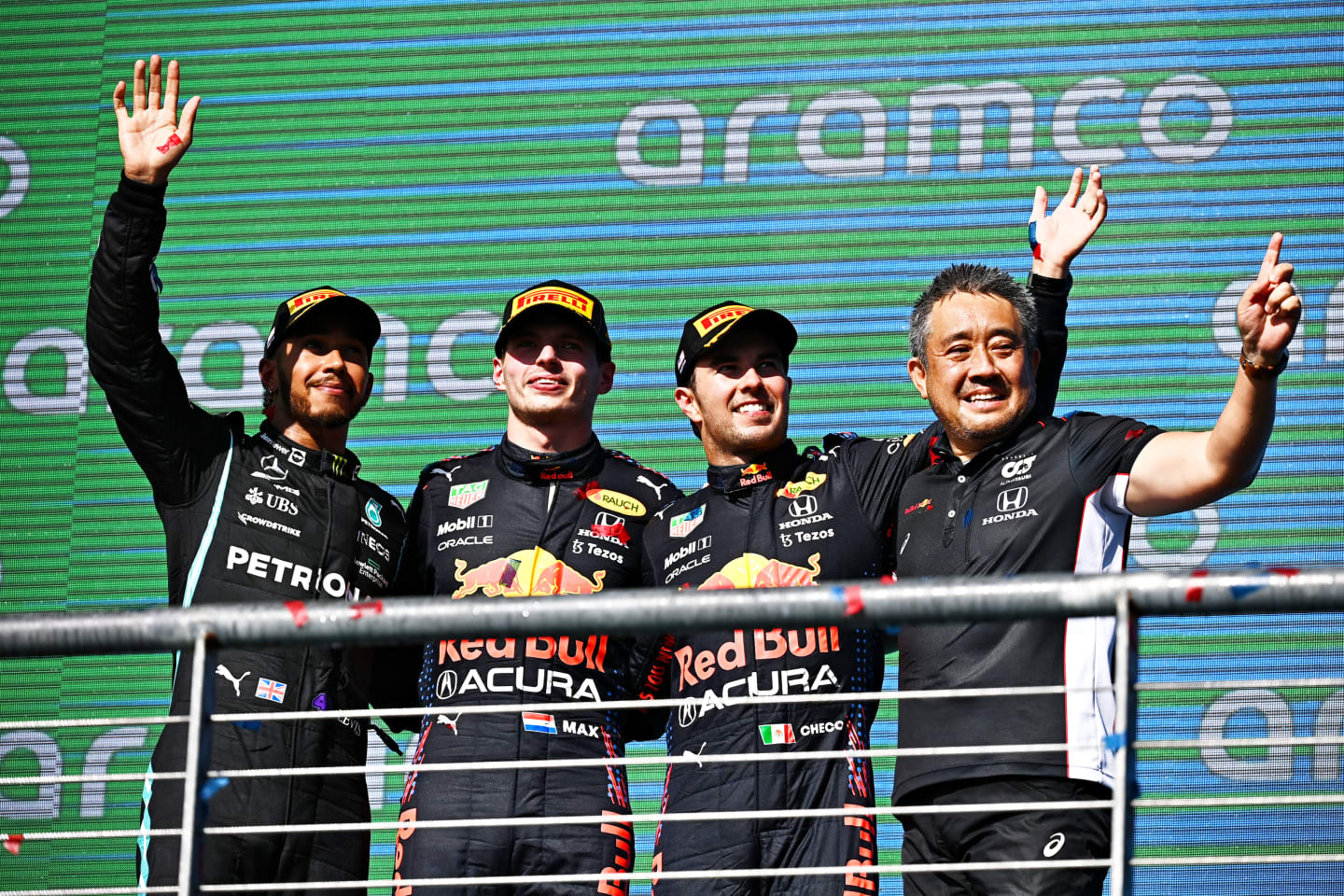 AUSTIN, TEXAS - OCTOBER 24: Race winner Max Verstappen of Netherlands and Red Bull Racing, second placed Lewis Hamilton of Great Britain and Mercedes GP, third placed Sergio Perez of Mexico and Red Bull Racing and Masashi Yamamoto of Honda celebrate on the podium during the F1 Grand Prix of USA at Circuit of The Americas on October 24, 2021 in Austin, Texas. (Photo by Clive Mason - Formula 1/Formula 1 via Getty Images)