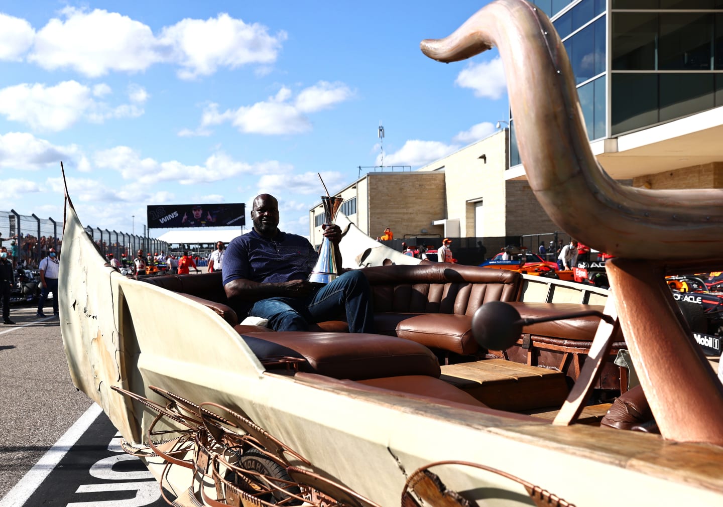 AUSTIN, TEXAS - OCTOBER 24: NBA legend Shaquille O'Neal brings the race winners trophy to the