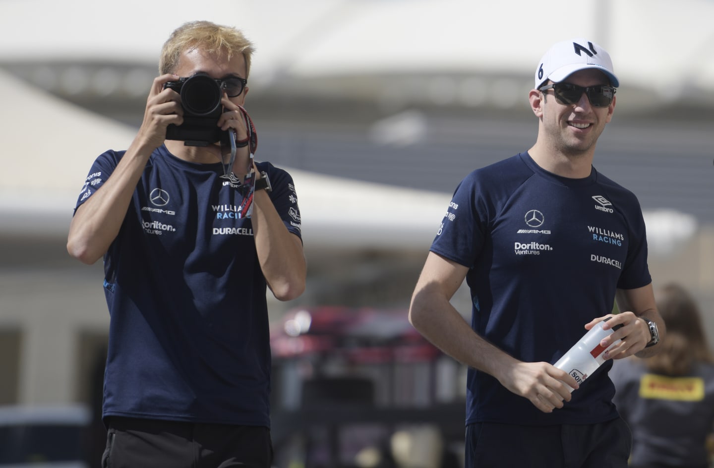 ABU DHABI, UNITED ARAB EMIRATES - NOVEMBER 18: Alexander Albon of Thailand and Williams and Nicholas Latifi of Canada and Williams walk in the paddock prior to practice ahead of the F1 Grand Prix of Abu Dhabi at Yas Marina Circuit on November 18, 2022 in Abu Dhabi, United Arab Emirates. (Photo by Rudy Carezzevoli/Getty Images)