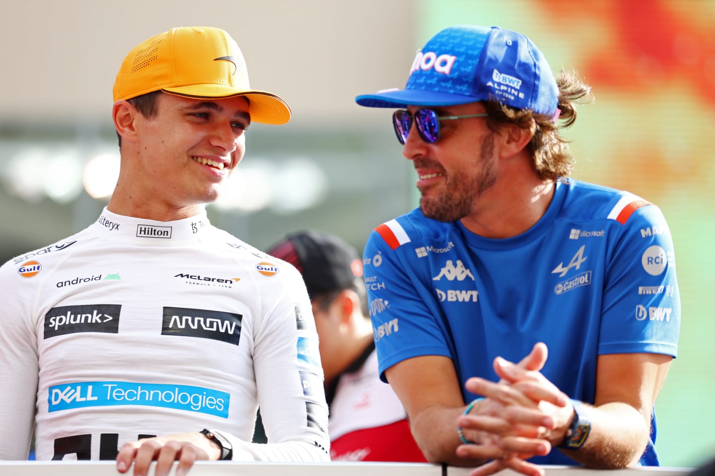 ABU DHABI, UNITED ARAB EMIRATES - NOVEMBER 20: Lando Norris of Great Britain and McLaren talks with Fernando Alonso of Spain and Alpine F1 on the drivers parade prior to the F1 Grand Prix of Abu Dhabi at Yas Marina Circuit on November 20, 2022 in Abu Dhabi, United Arab Emirates. (Photo by Bryn Lennon - Formula 1/Formula 1 via Getty Images)