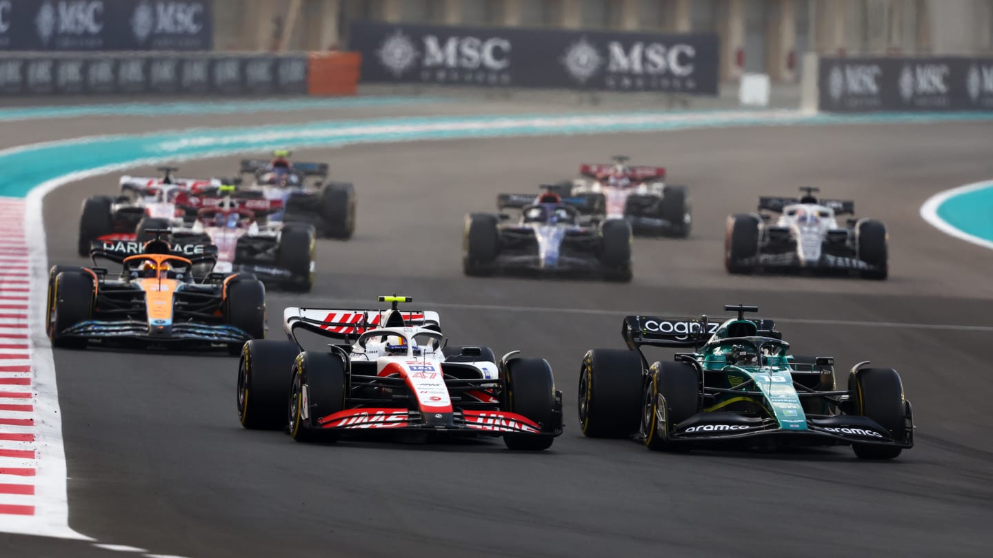 ABU DHABI, UNITED ARAB EMIRATES - NOVEMBER 20: Mick Schumacher of Germany driving the (47) Haas F1 VF-22 Ferrari and Lance Stroll of Canada driving the (18) Aston Martin AMR22 Mercedes battle for position on track during the F1 Grand Prix of Abu Dhabi at Yas Marina Circuit on November 20, 2022 in Abu Dhabi, United Arab Emirates. (Photo by Bryn Lennon - Formula 1/Formula 1 via Getty Images)