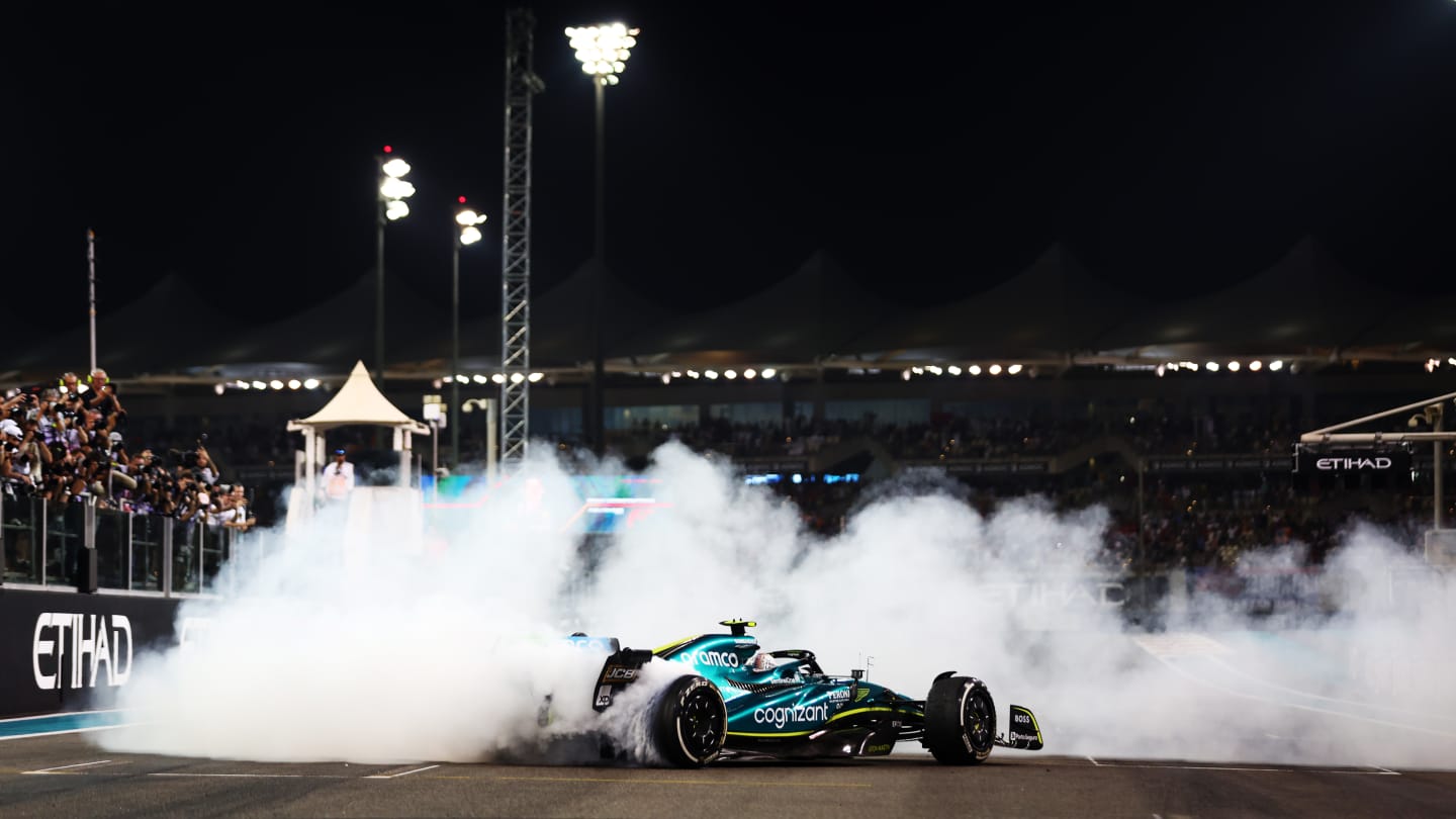 ABU DHABI, UNITED ARAB EMIRATES - NOVEMBER 20: Tenth placed Sebastian Vettel of Germany driving the (5) Aston Martin AMR22 Mercedes performs donuts at the end of his final race during the F1 Grand Prix of Abu Dhabi at Yas Marina Circuit on November 20, 2022 in Abu Dhabi, United Arab Emirates. (Photo by Dan Istitene - Formula 1/Formula 1 via Getty Images)