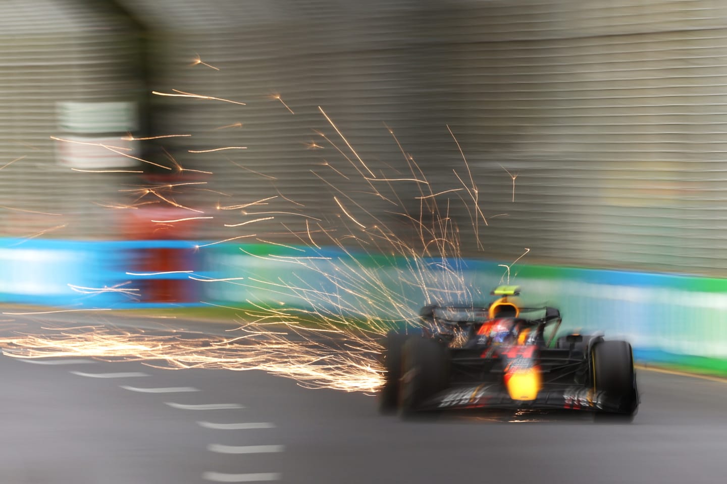 MELBOURNE, AUSTRALIA - APRIL 08: Sparks fly behind Sergio Perez of Mexico driving the (11) Oracle