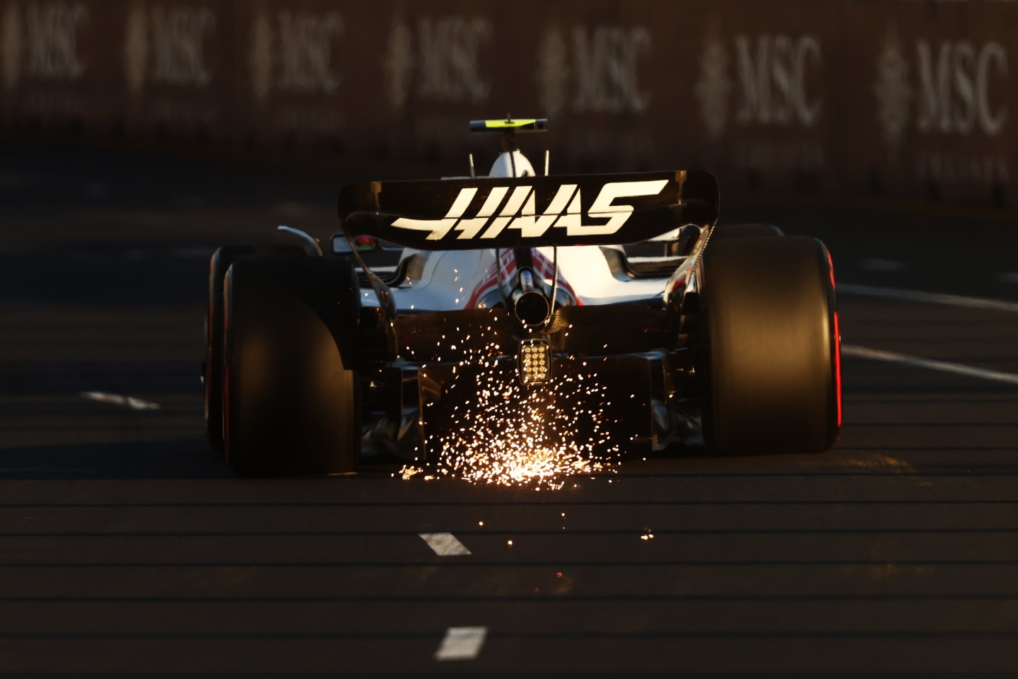 MELBOURNE, AUSTRALIA - APRIL 09: Sparks fly behind Mick Schumacher of Germany driving the (47) Haas F1 VF-22 Ferrari on track during qualifying ahead of the F1 Grand Prix of Australia at Melbourne Grand Prix Circuit on April 09, 2022 in Melbourne, Australia. (Photo by Bryn Lennon - Formula 1/Formula 1 via Getty Images)