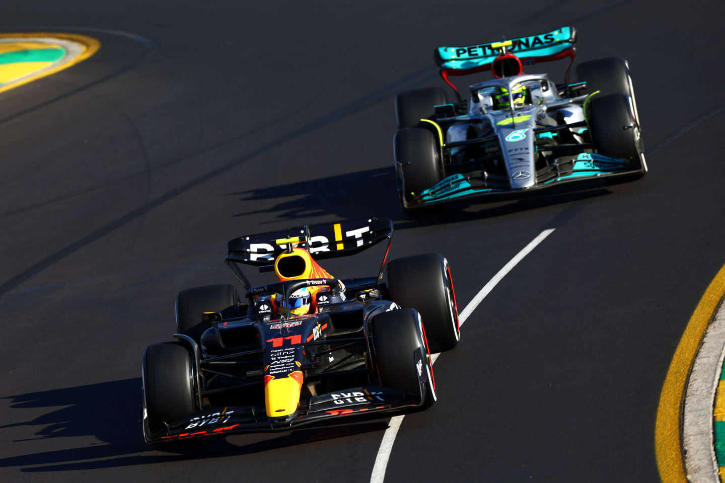 MELBOURNE, AUSTRALIA - APRIL 10: Sergio Perez of Mexico driving the (11) Oracle Red Bull Racing RB18 leads Lewis Hamilton of Great Britain driving the (44) Mercedes AMG Petronas F1 Team W13 during the F1 Grand Prix of Australia at Melbourne Grand Prix Circuit on April 10, 2022 in Melbourne, Australia. (Photo by Mark Thompson/Getty Images)