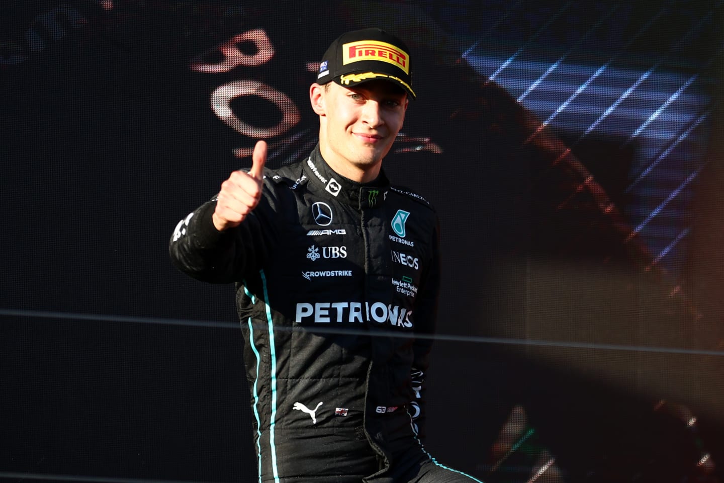 MELBOURNE, AUSTRALIA - APRIL 10: Third placed George Russell of Great Britain and Mercedes celebrates on the podium during the F1 Grand Prix of Australia at Melbourne Grand Prix Circuit on April 10, 2022 in Melbourne, Australia. (Photo by Bryn Lennon - Formula 1/Formula 1 via Getty Images)