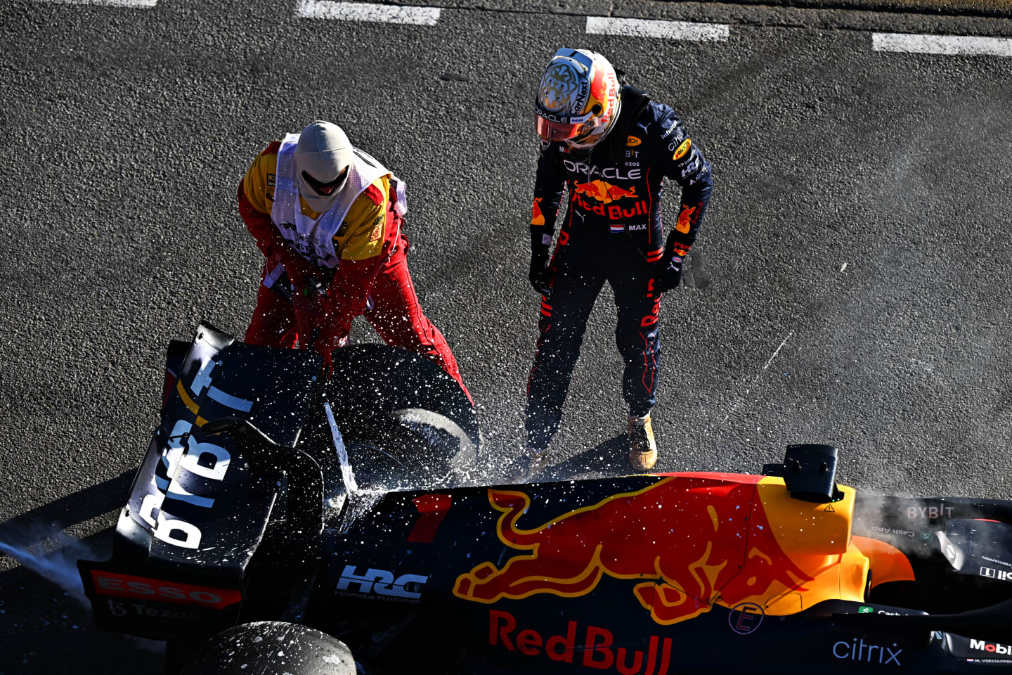 MELBOURNE, AUSTRALIA - APRIL 10: Max Verstappen of the Netherlands and Oracle Red Bull Racing and track marshals tend to the fire in his car after he retired from the race during the F1 Grand Prix of Australia at Melbourne Grand Prix Circuit on April 10, 2022 in Melbourne, Australia. (Photo by Clive Mason/Getty Images)