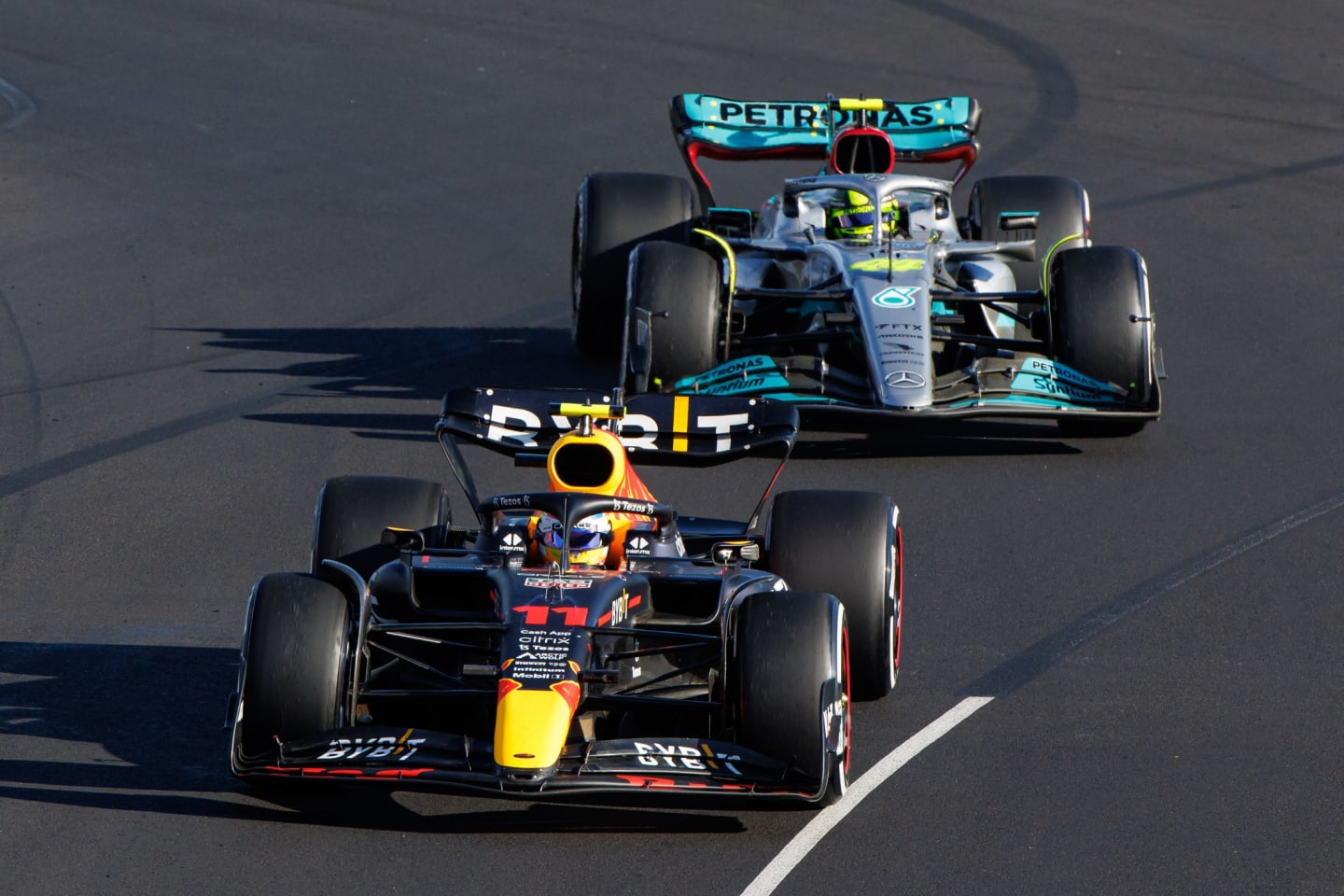 MELBOURNE, AUSTRALIA - APRIL 10: Sergio Perez of Mexico in his Red Bull being pursued by Lewis