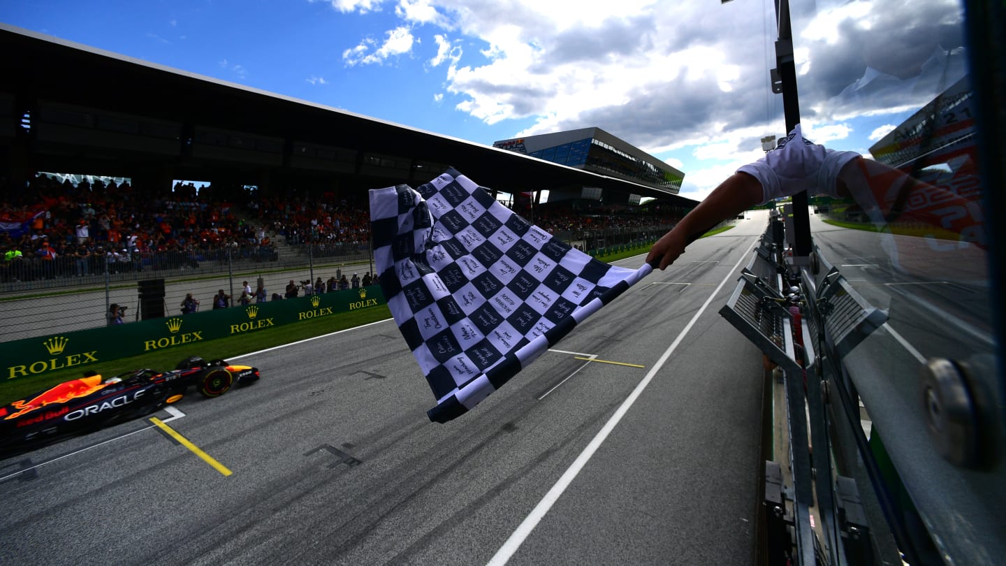 SPIELBERG, AUSTRIA - JULY 09: Sprint winner Max Verstappen of the Netherlands driving the (1) Oracle Red Bull Racing RB18 takes the chequered flag during the F1 Grand Prix of Austria Sprint at Red Bull Ring on July 09, 2022 in Spielberg, Austria. (Photo by Mario Renzi - Formula 1/Formula 1 via Getty Images)
