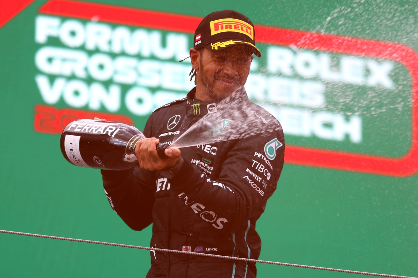 SPIELBERG, AUSTRIA - JULY 10: Third placed Lewis Hamilton of Great Britain and Mercedes celebrates on the podium during the F1 Grand Prix of Austria at Red Bull Ring on July 10, 2022 in Spielberg, Austria. (Photo by Bryn Lennon/Getty Images)