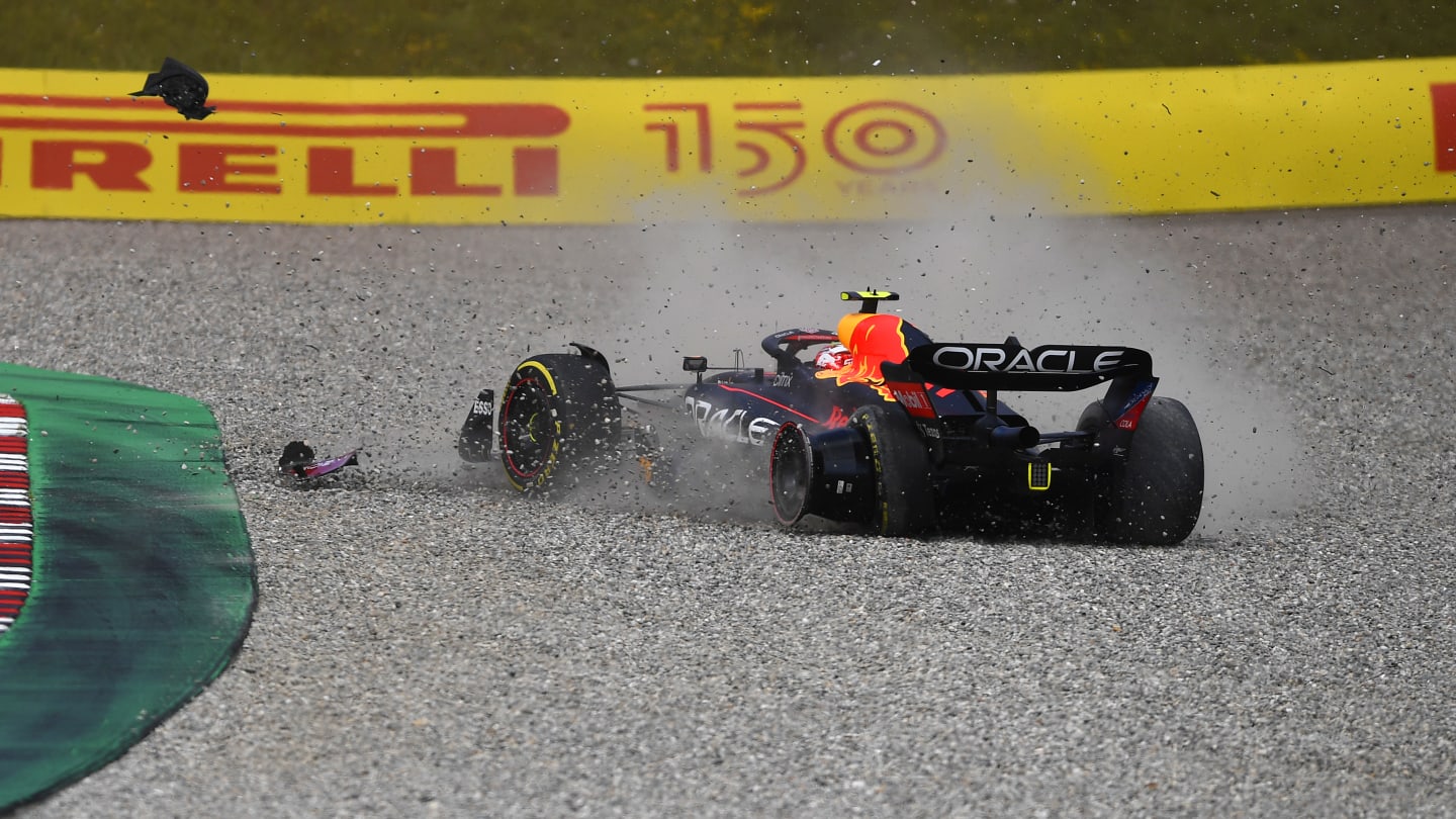 SPIELBERG, AUSTRIA - JULY 10: Sergio Perez of Mexico driving the (11) Oracle Red Bull Racing RB18 runs through the gravel after a collision with George Russell of Great Britain and Mercedes during the F1 Grand Prix of Austria at Red Bull Ring on July 10, 2022 in Spielberg, Austria. (Photo by Rudy Carezzevoli - Formula 1/Formula 1 via Getty Images)
