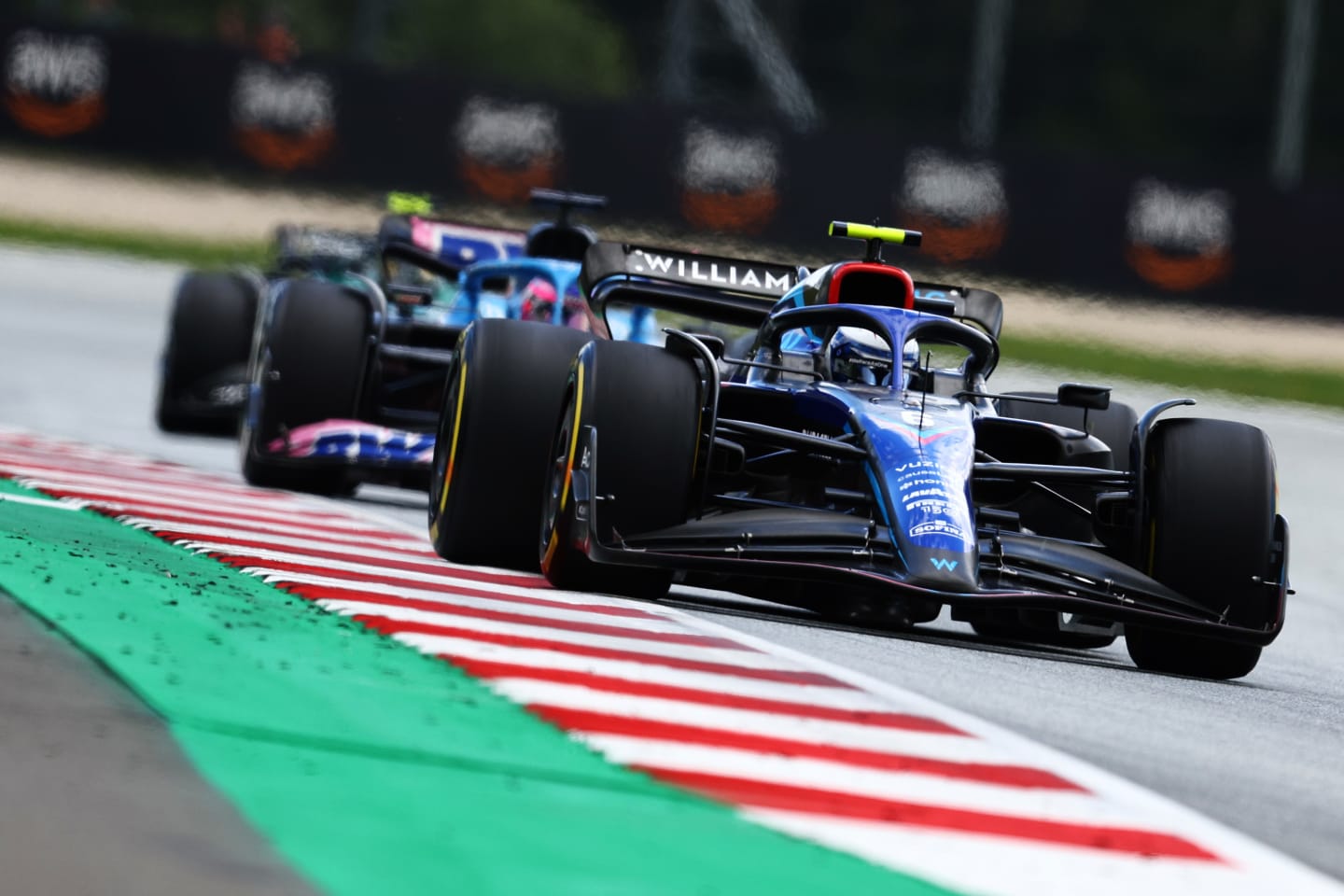 SPIELBERG, AUSTRIA - JULY 10: Nicholas Latifi of Canada driving the (6) Williams FW44 Mercedes leads Fernando Alonso of Spain driving the (14) Alpine F1 A522 Renault during the F1 Grand Prix of Austria at Red Bull Ring on July 10, 2022 in Spielberg, Austria. (Photo by Clive Rose/Getty Images)