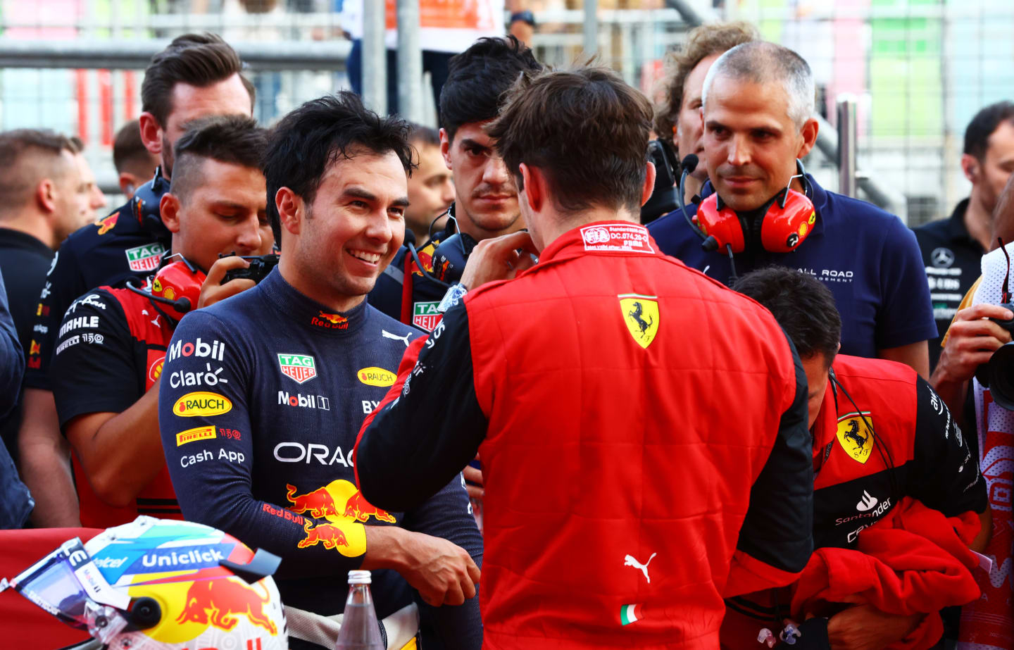 BAKU, AZERBAIJAN - JUNE 11: Second placed qualifier Sergio Perez of Mexico and Oracle Red Bull Racing talks with Pole position qualifier Charles Leclerc of Monaco and Ferrari in parc ferme during qualifying ahead of the F1 Grand Prix of Azerbaijan at Baku City Circuit on June 11, 2022 in Baku, Azerbaijan. (Photo by Mark Thompson/Getty Images)