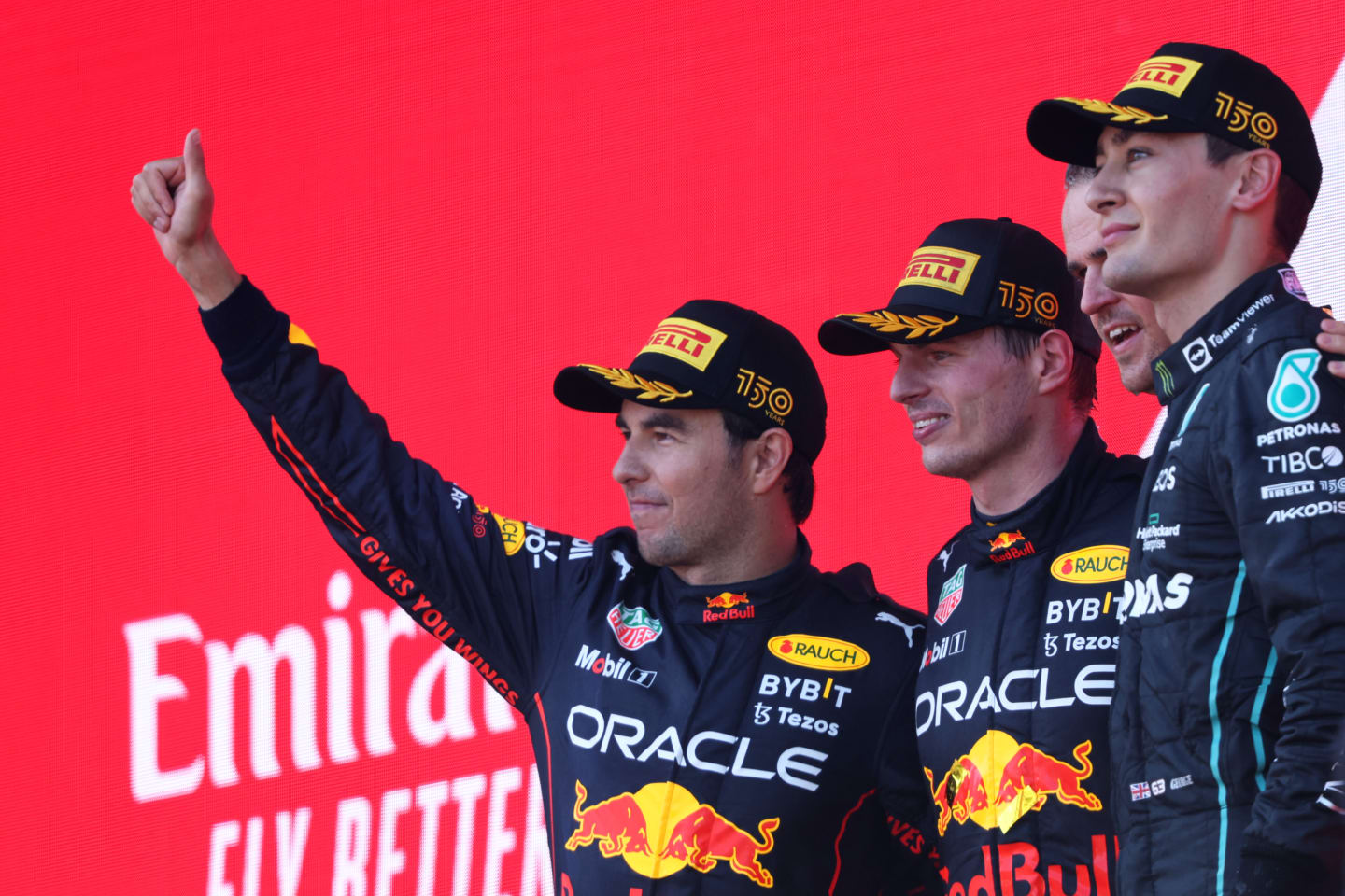 BAKU, AZERBAIJAN - JUNE 12: Race winner Max Verstappen of the Netherlands and Oracle Red Bull Racing (second from left), Second placed Sergio Perez of Mexico and Oracle Red Bull Racing (L), Third placed George Russell of Great Britain and Mercedes (R) and Tom Hart Performance Engineer at Red Bull Racing (second from right) celebrate on the podium during the F1 Grand Prix of Azerbaijan at Baku City Circuit on June 12, 2022 in Baku, Azerbaijan. (Photo by Bryn Lennon - Formula 1/Formula 1 via Getty Images)