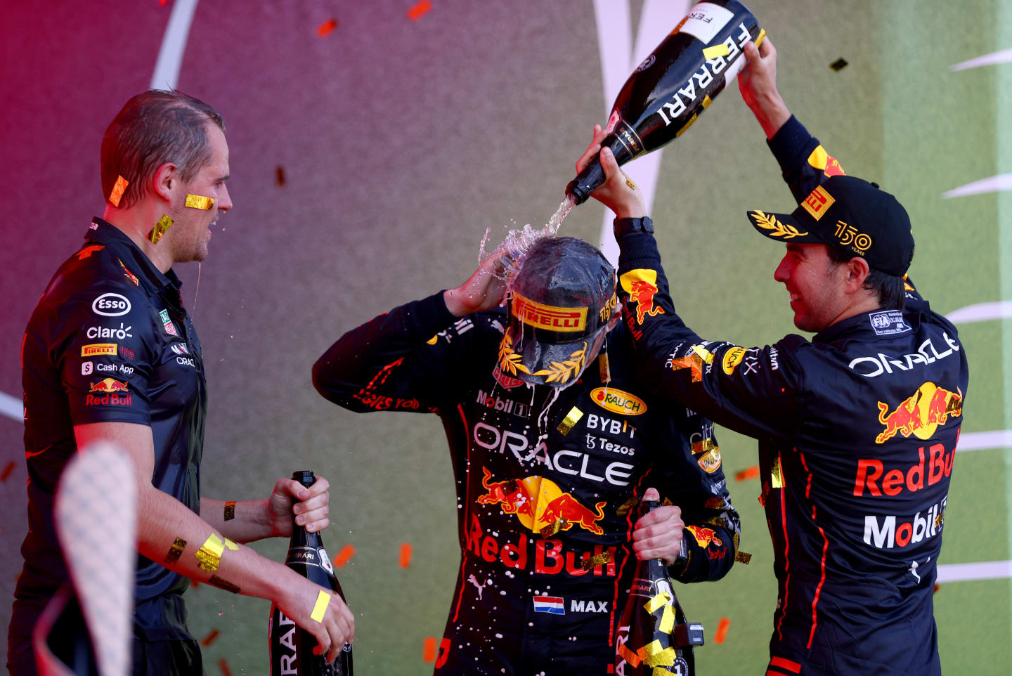 BAKU, AZERBAIJAN - JUNE 12: Race winner Max Verstappen of the Netherlands and Oracle Red Bull Racing, Second placed Sergio Perez of Mexico and Oracle Red Bull Racing and Tom Hart, Performance Engineer at Red Bull Racing celebrate on the podium during the F1 Grand Prix of Azerbaijan at Baku City Circuit on June 12, 2022 in Baku, Azerbaijan. (Photo by Dan Istitene - Formula 1/Formula 1 via Getty Images)